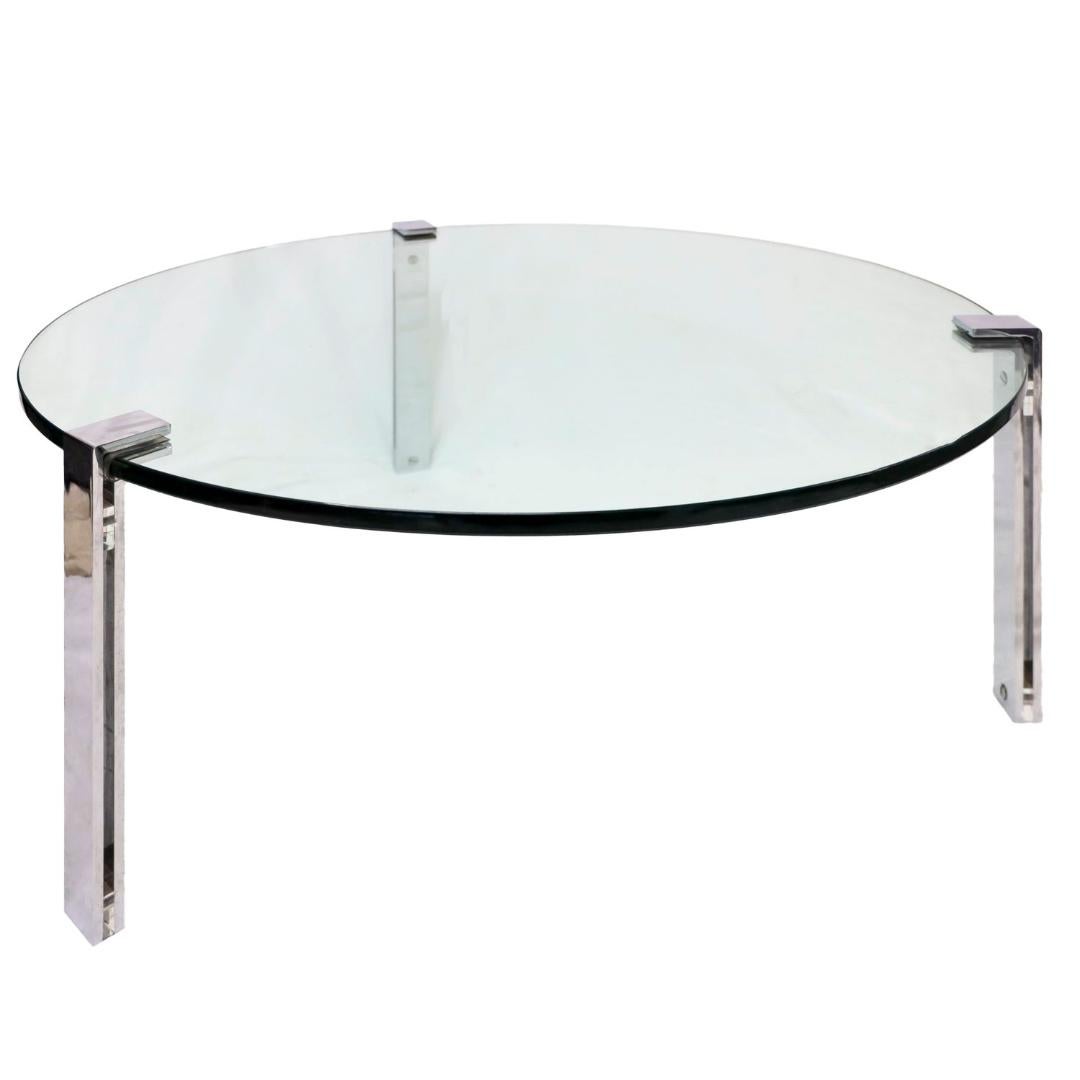 Sleek and understated, this vintage minimalist coffee table suspends thick glass between 3 chrome legs, offering a timeless blend of form and function. Wear is consistent with age and use with slight scratches on glass and legs. See photos for