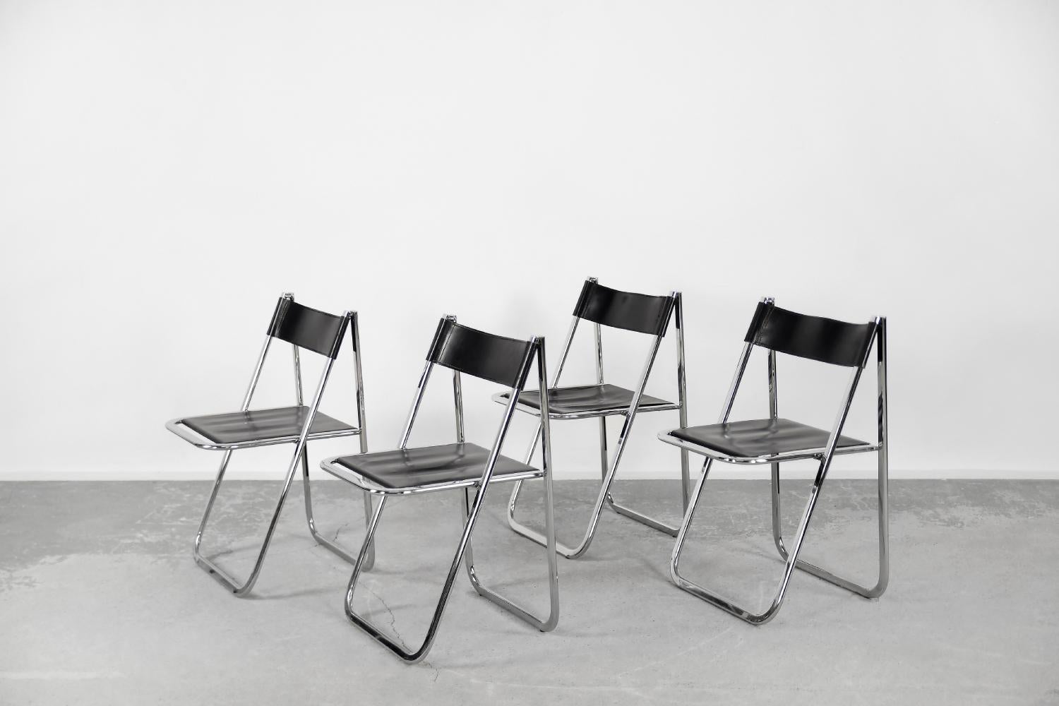 This set of four Tamara chairs was manufactured by the Italian Arrben factory during the 1970s. The frame is made of a chrome-plated metal. The seat and backrest are upholstered with high-quality black natural leather. The minimalist form of the