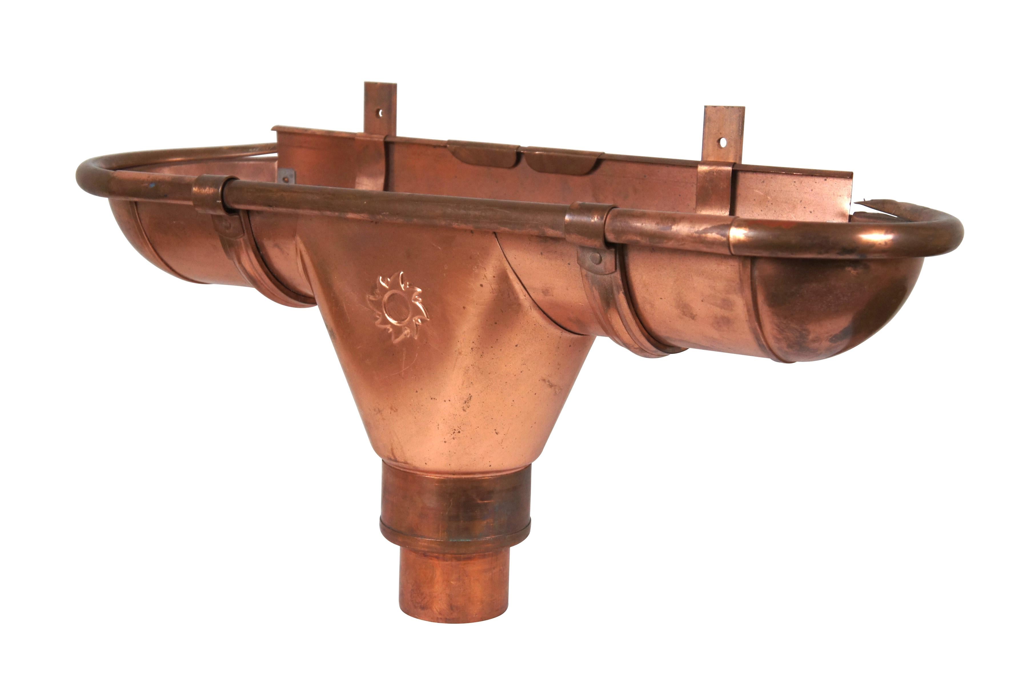 Late 20th century Minoletti copper downspout gutter segment, outlet embossed with a sun, and half-spherical end caps. Includes base connector and one support bracket. Numbered 330/100.

Dimensions:
25