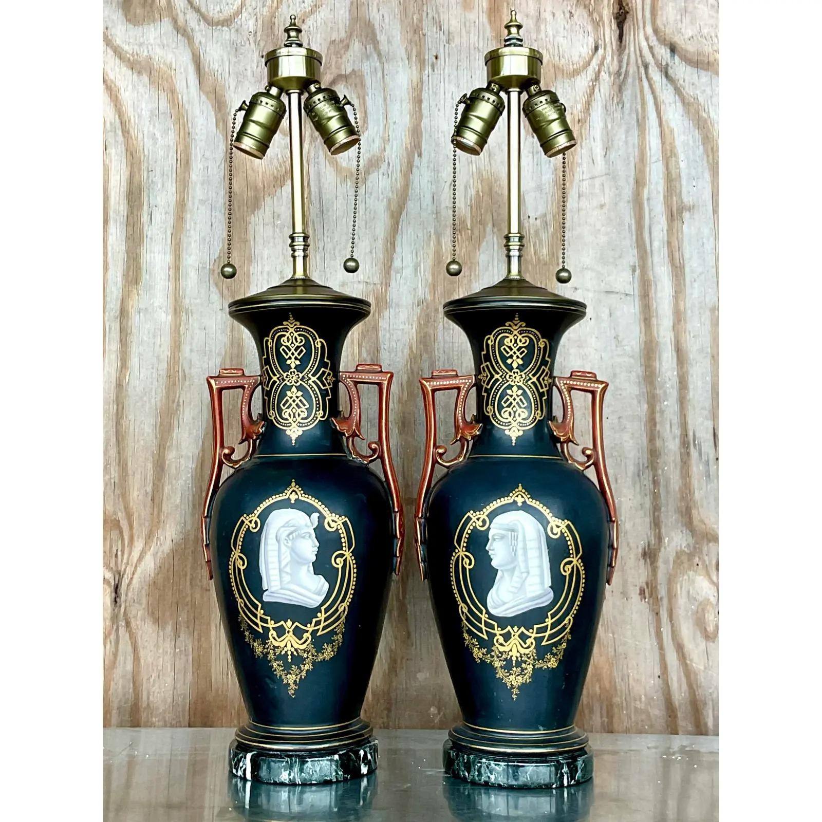 Incredible pair of vintage Minton table lamps. A dramatic transfer print of Egyptian Pharaohs on a matte black background. All new hardware, wiring and black marble plinths. Acquired from a Palm Beach estate.