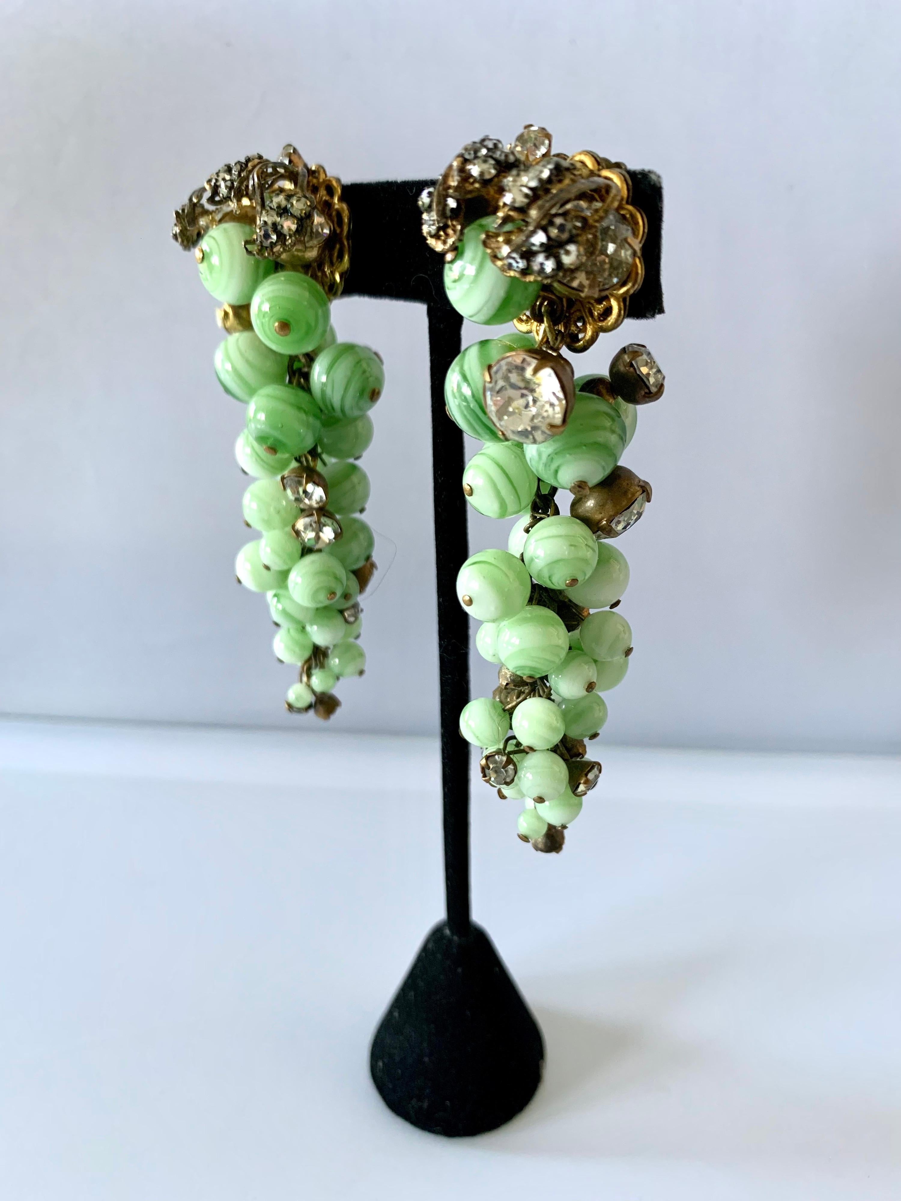 Scarce Miriam Haskell grape cluster clip-on earrings, designed by Robert F. Clark for Miriam Haskell circa 1955. Comprised out of gilt metal, French swirl green glass beads, and rhinestones 