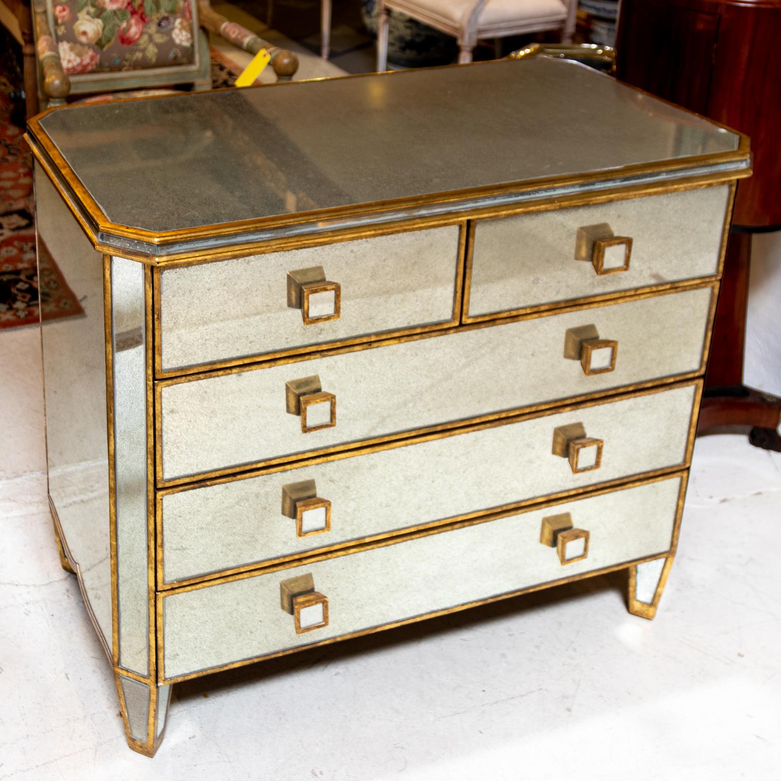 Circa mid-20th century vintage Hollywood Regency style mirrored chest of drawers with gold gilded accent trim, square pulls, and plain tapered legs. Made in Italy. Please note of wear consistent with age.