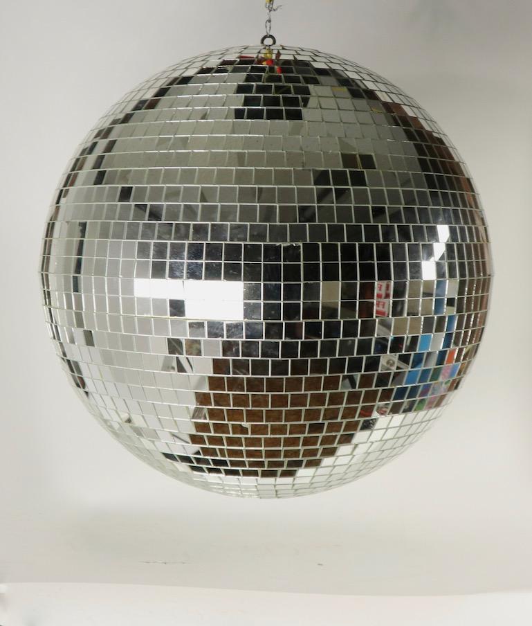 Stunning vintage mirrored disco ball in very good original condition. This example shows only very light signs of its age, specifically a couple of cracked panels, which are inconsequential. Ready to hang and start the party.