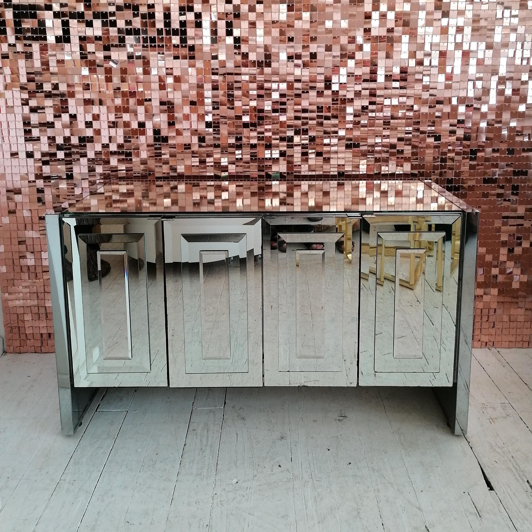 Stunning mirror glass & chromed steel sideboard by Ello Furniture, USA 1980s .
The four doors have multi-layered bevelled mirror glass fronts. Top is mirror glass; ends and trim are chrome. Chrome tab handles. Inside are 2 adjustable shelves.
Some