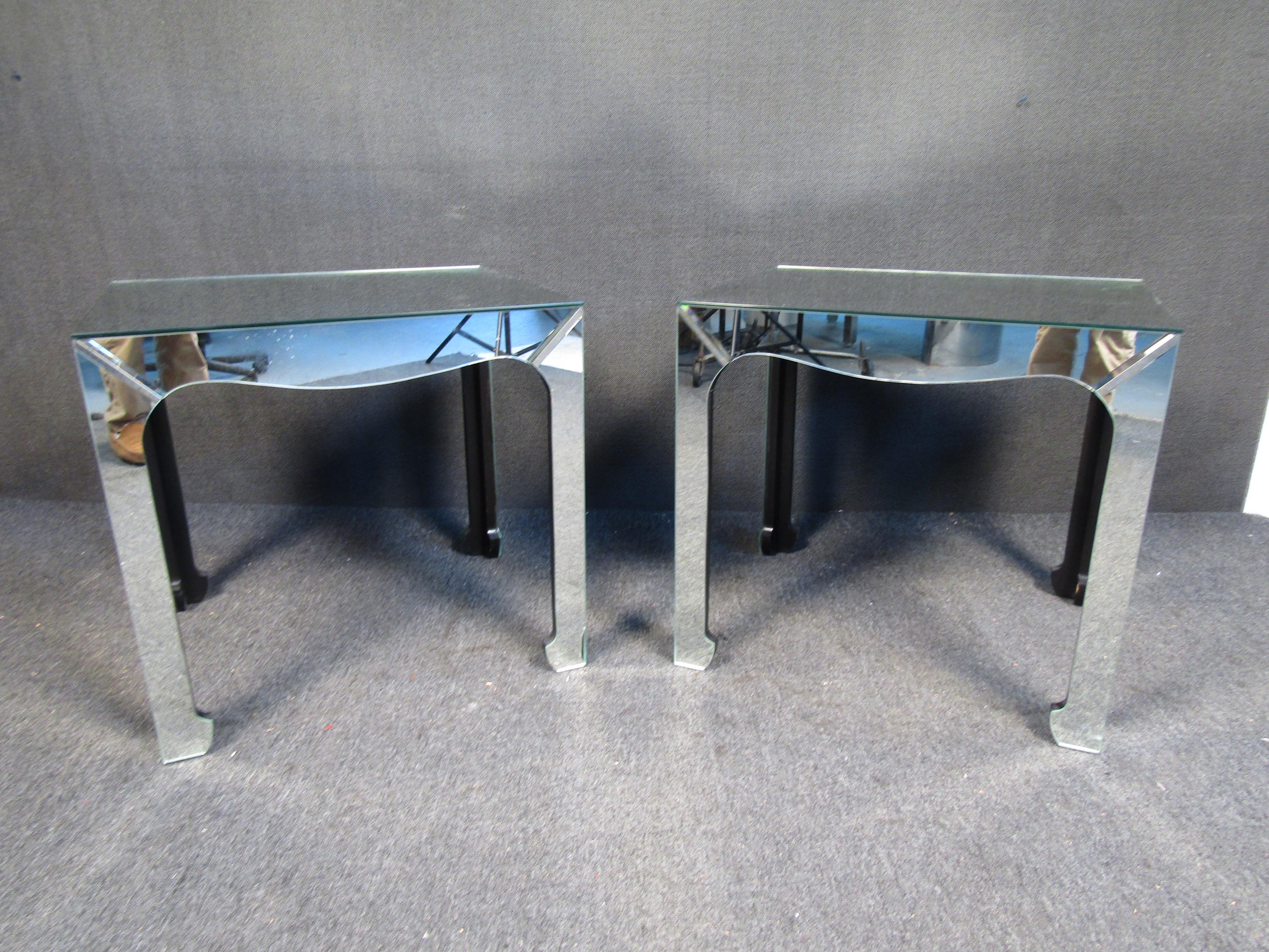 These eye-catching mirrored glass tables feature rectangular tops and oddly shaped legs. These side tables will surely pair to any bright or modern living space.

Please confirm item location (NJ or NY).