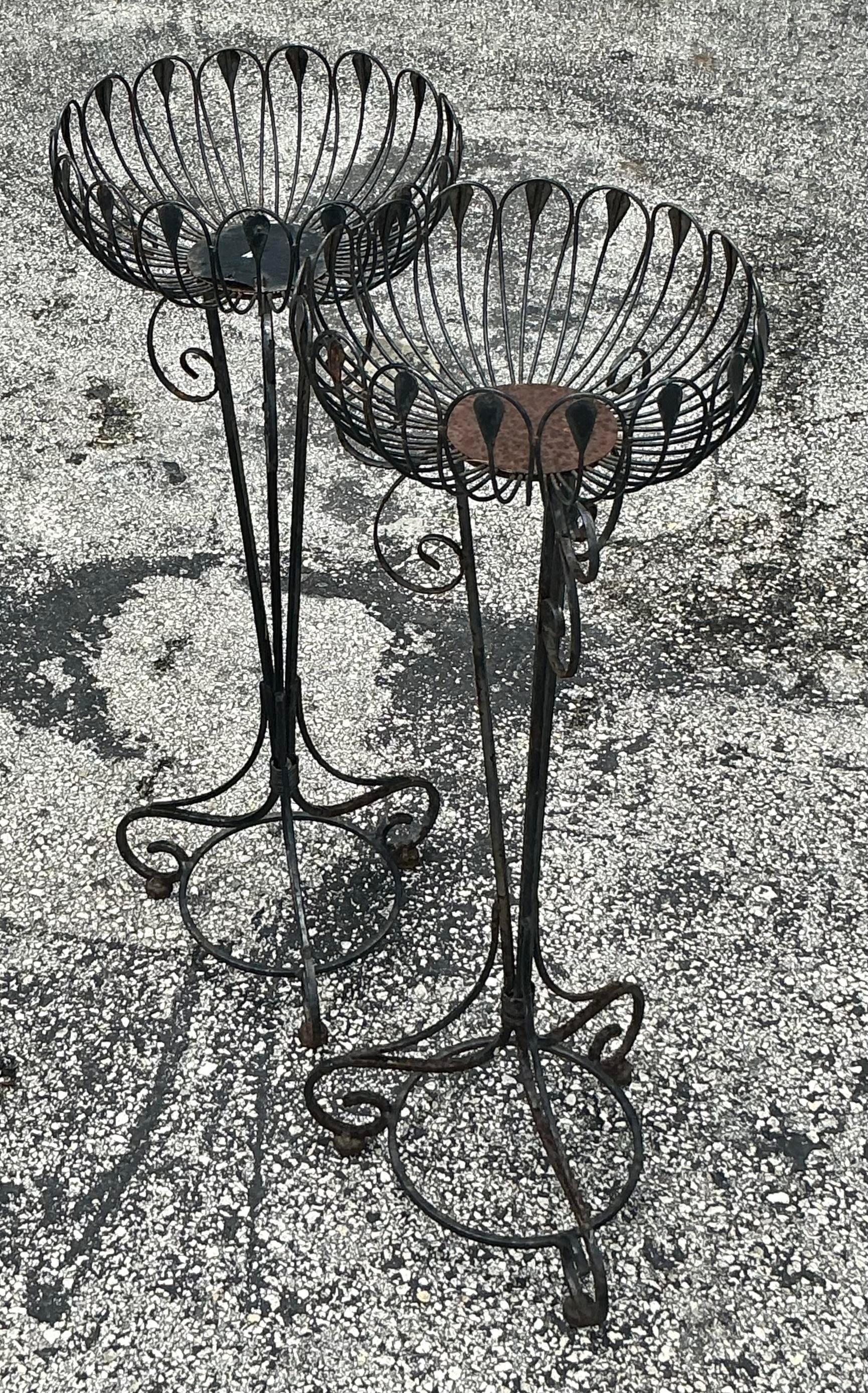 Showcase your greenery with these Vintage MCM Wrought Iron Plant Stands. Featuring sleek mid-century modern design and durable wrought iron construction, these stands add a touch of retro elegance and sophistication to any space. Perfect for