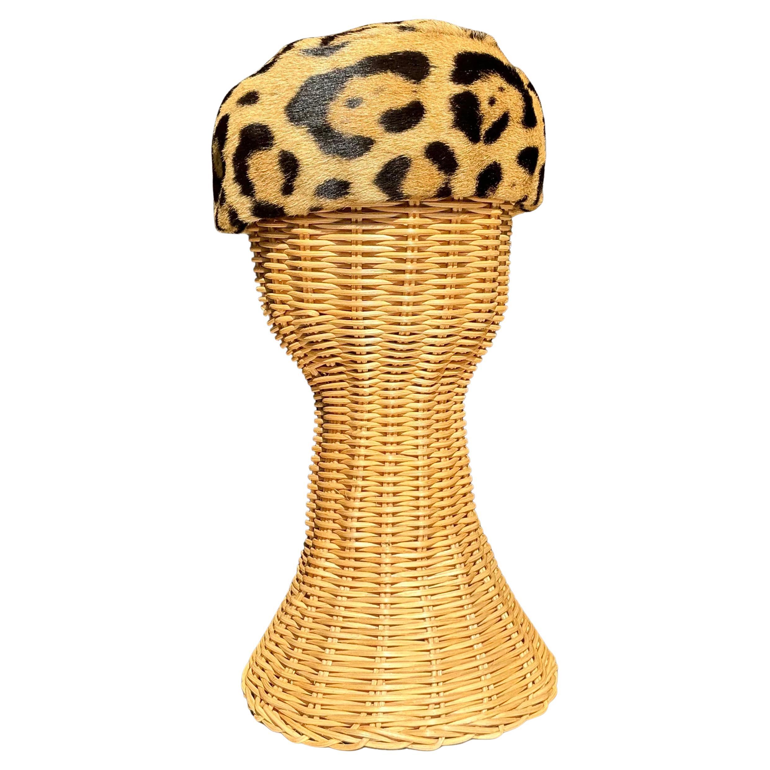 This Vintage Miss Alice Leopard Print Fur Pillbox Hat is a stylish and sophisticated piece of headwear that blends classic fashion with bold, animal-inspired patterns. Miss Alice, a designer known for her vintage hats, created pieces that were often