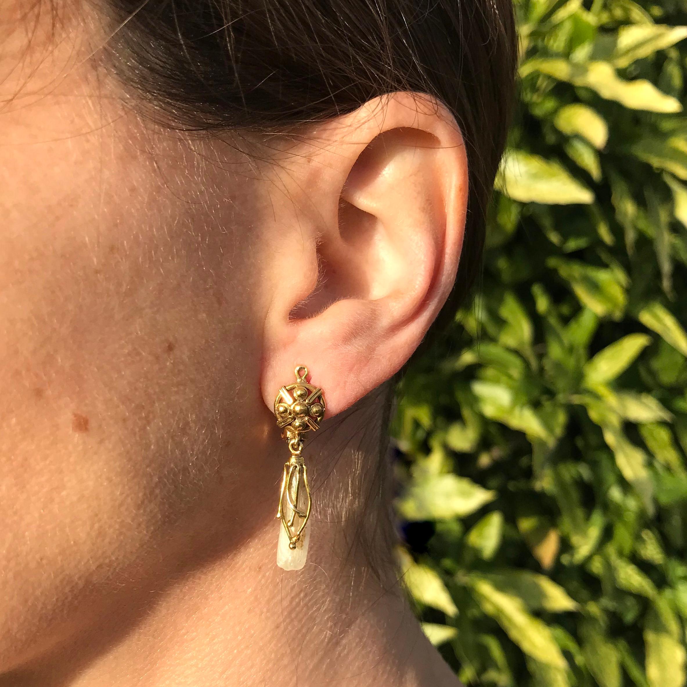 Delightfully unique! This rare pair of fresh water Mississippi river pearls are showcased in a stunning drop earring setting. Organic vine shaped tendrils wrap around each pearl, and hang from round top plate which is backed with lever-back