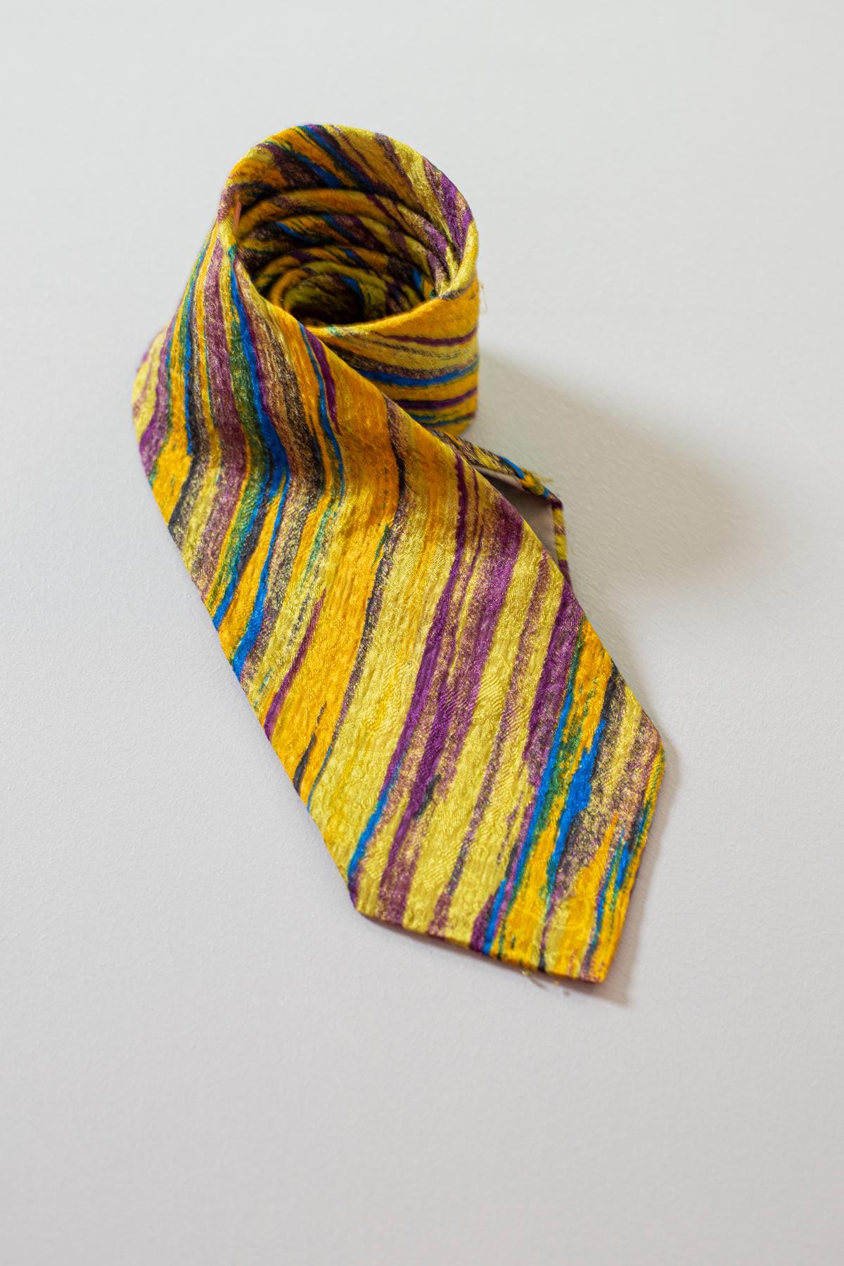 With a particular, bizarre and colorful design, this tie is Designed by Missoni, it mirrors the great Italian taste in fashion. This tie is vintage and it is made of all-silk. Decorated with barely sketched stripes of various very bright colors.