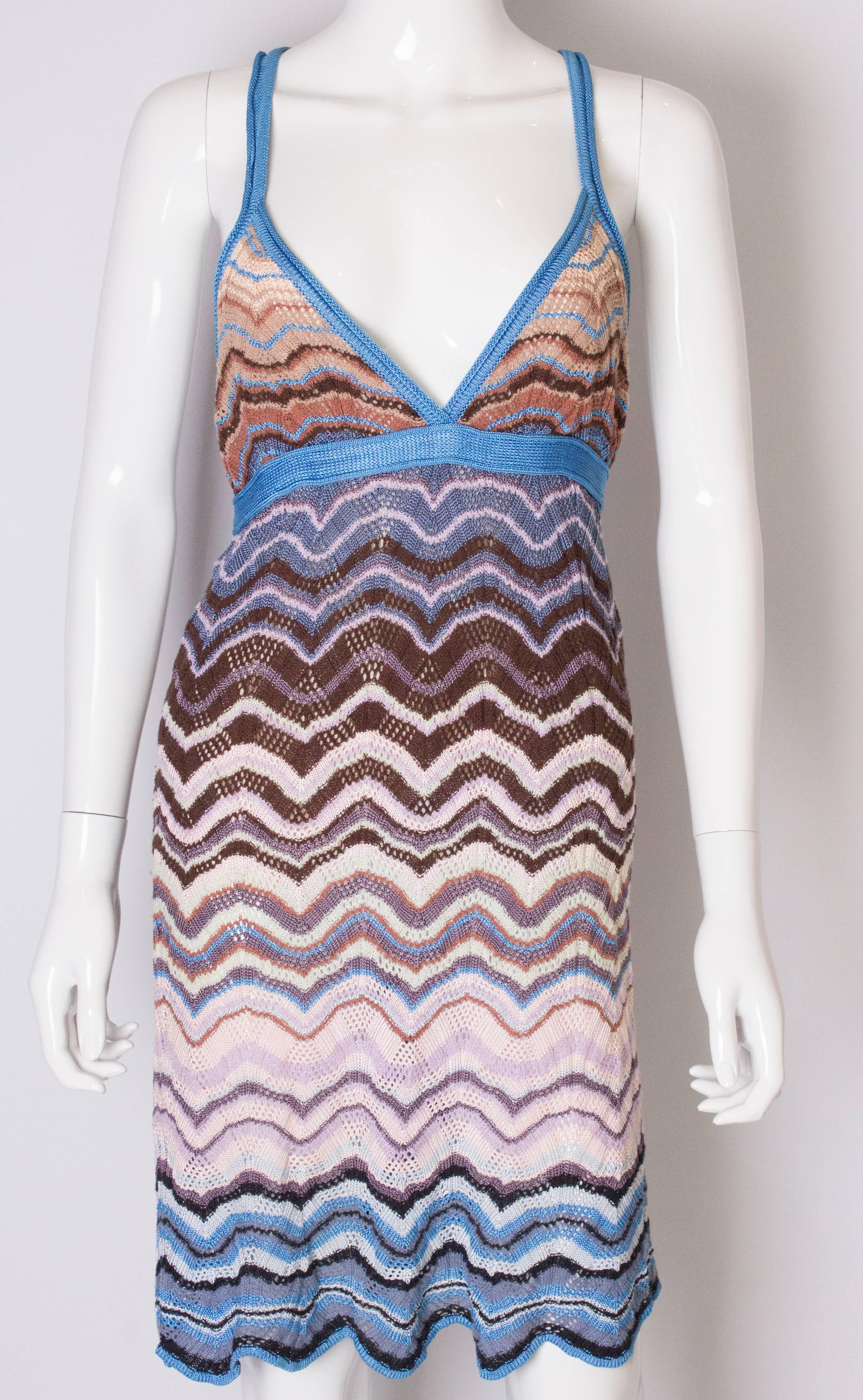 A chic sundress by Missoni, Brown label. The dress is in blue  browns and cream with a cross over back. It is lined in silk.
