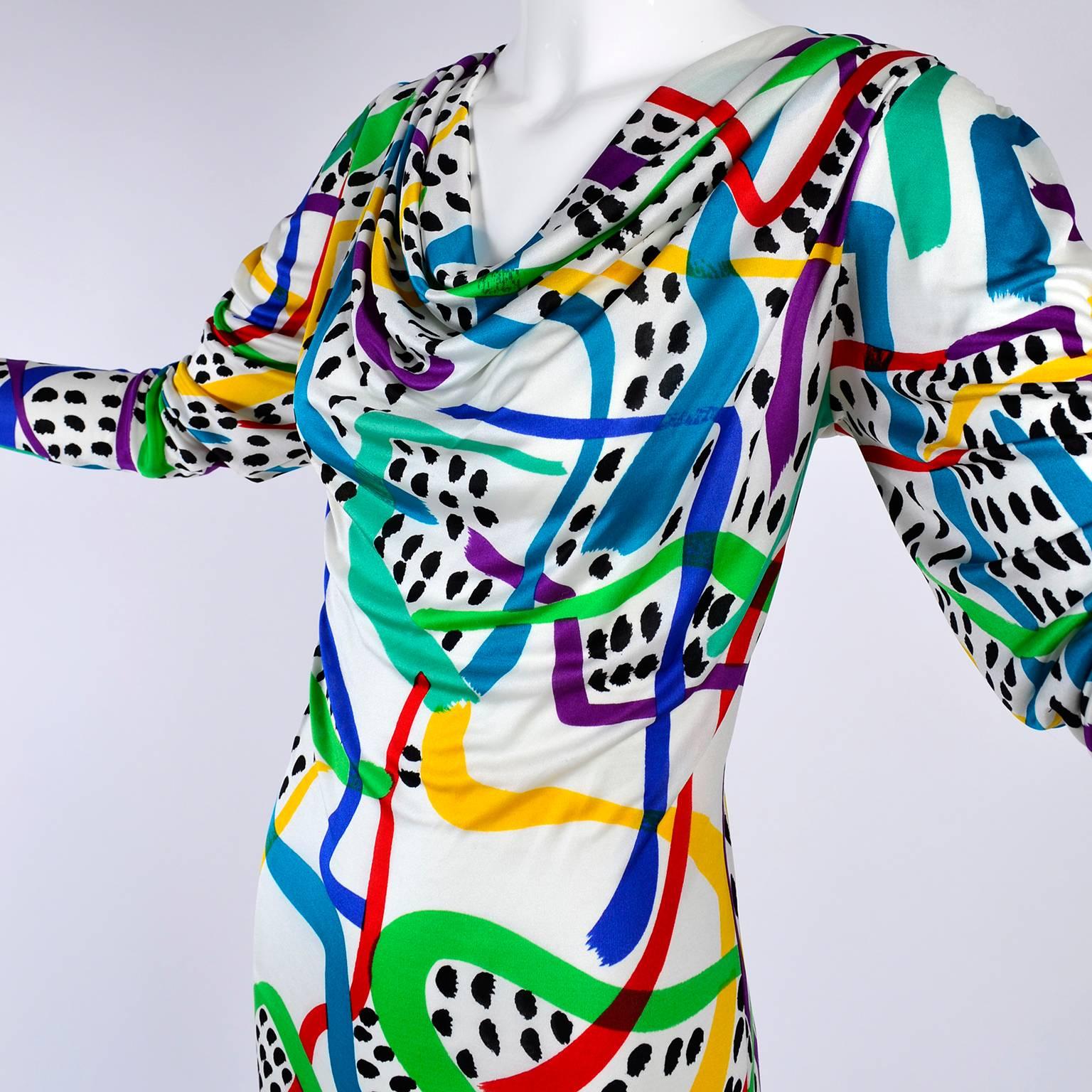 This vintage Missoni dress still has its original tag and was never worn.  The silk jersey dress is in a multi color print with black dots and blue, green, yellow, purple and red abstract lines.  The dress was made for I Magnin and is labeled a size