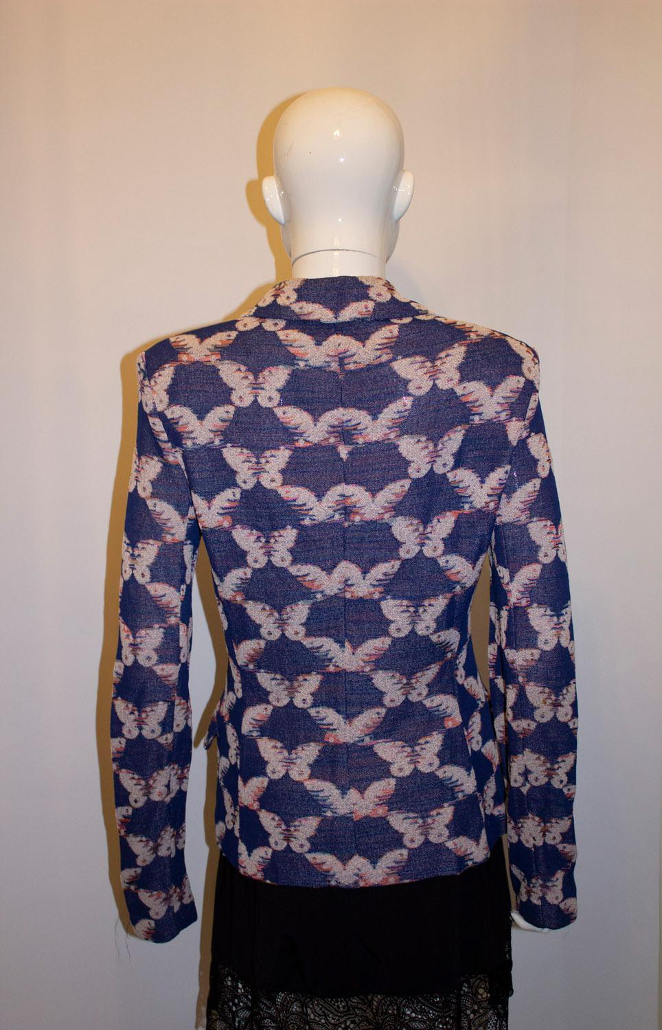 A pretty vintage jacket by Missoni , mainline . The jacket has a blue background with an attractive butterfly print. It has a three button opening, small shoulder pads and a pocket on either side. It is unlined. Size Italian 42, Bust 37'', length
