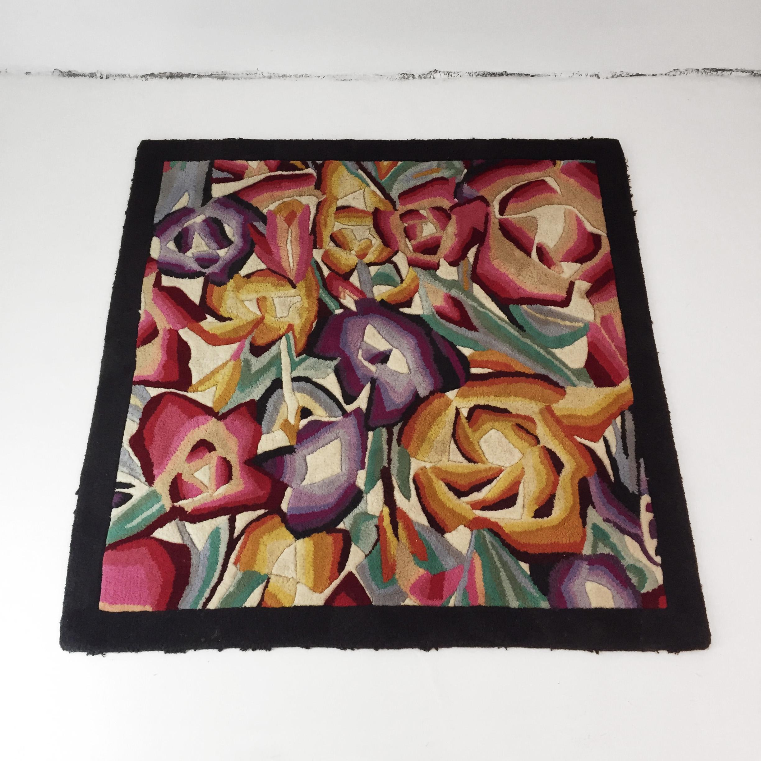 Beautiful flowers square rug by Missoni Home. Cubist roses and other flowers of thick wool weave composing a flower synthesis in vibrant colours framed by the black wool border. Imported from Italy. Original Missoni label lost on transportation,