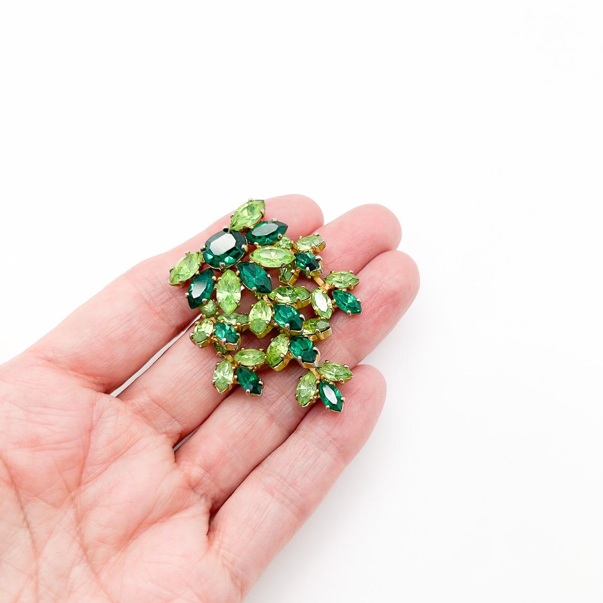 A Vintage Mitchel Maer Emerald Brooch. Tumbling shades of green catch the eye.
This adorable vintage Mitchel Maer brooch would have been made in London, England in the early 1950s. Mitchel Maer's work was sought-after, so much so between the years
