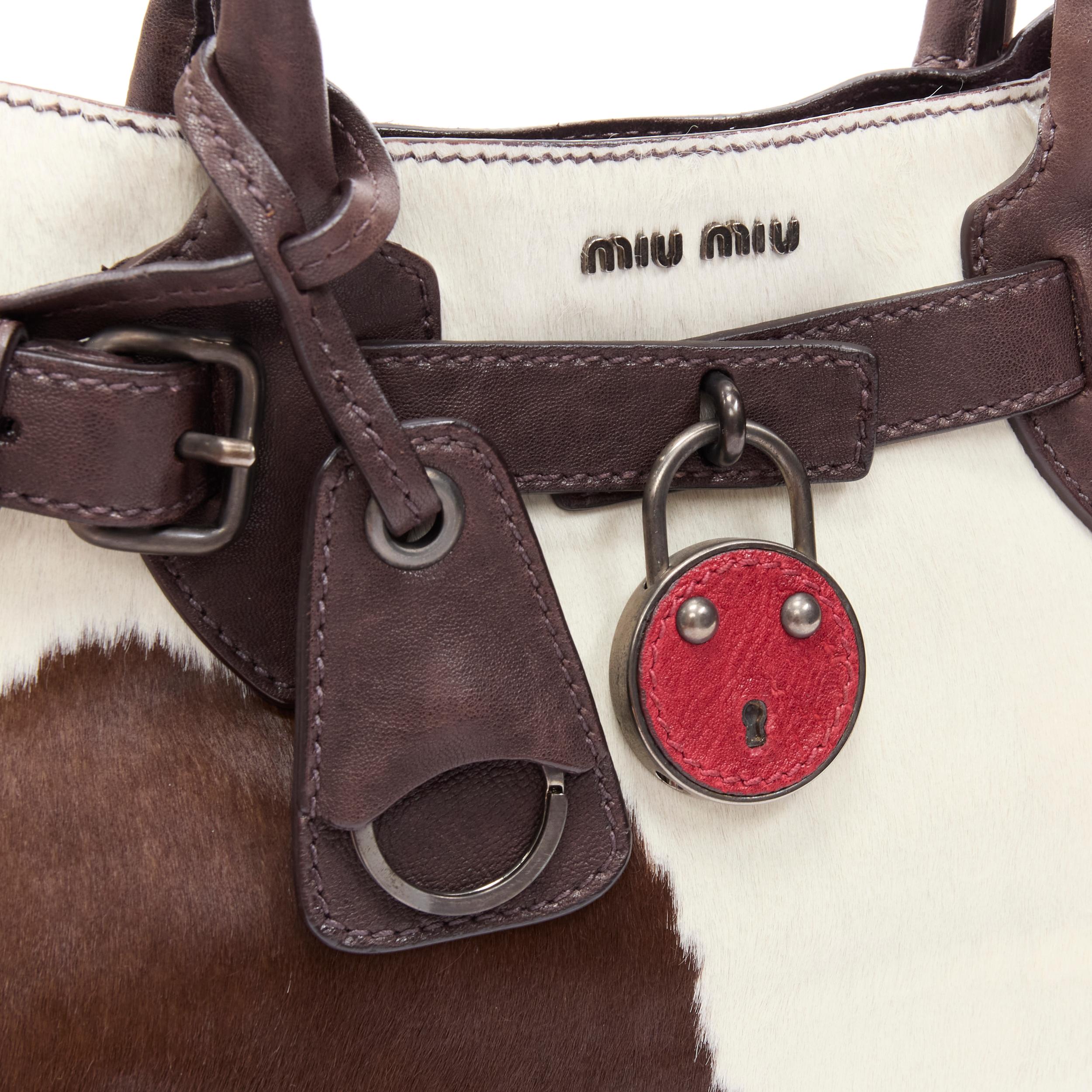 Black vintage MIU MIU brown white cow print horse half red lock satchel bag