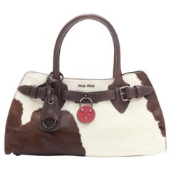 vintage MIU MIU brown white cow print horse half red lock satchel bag