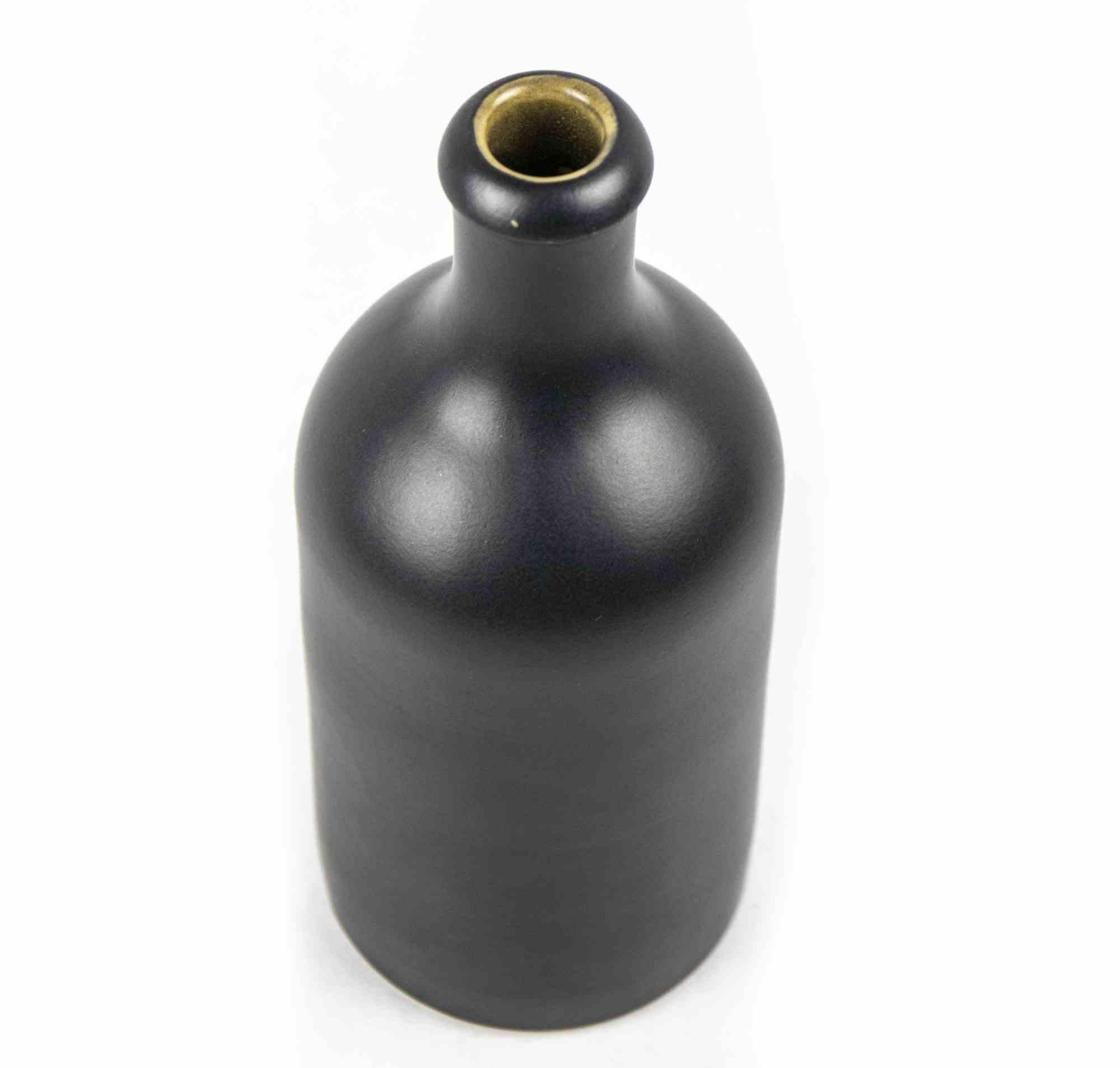 Vintage MKM stoneware is an original decorative object realized in the 1970s.

A vintage M.K.M. Keramik stoneware bottle with a cylindrical body leading up to a narrow neck.

Dark grey colored. Marked on lower part. Perfect to preserve oil