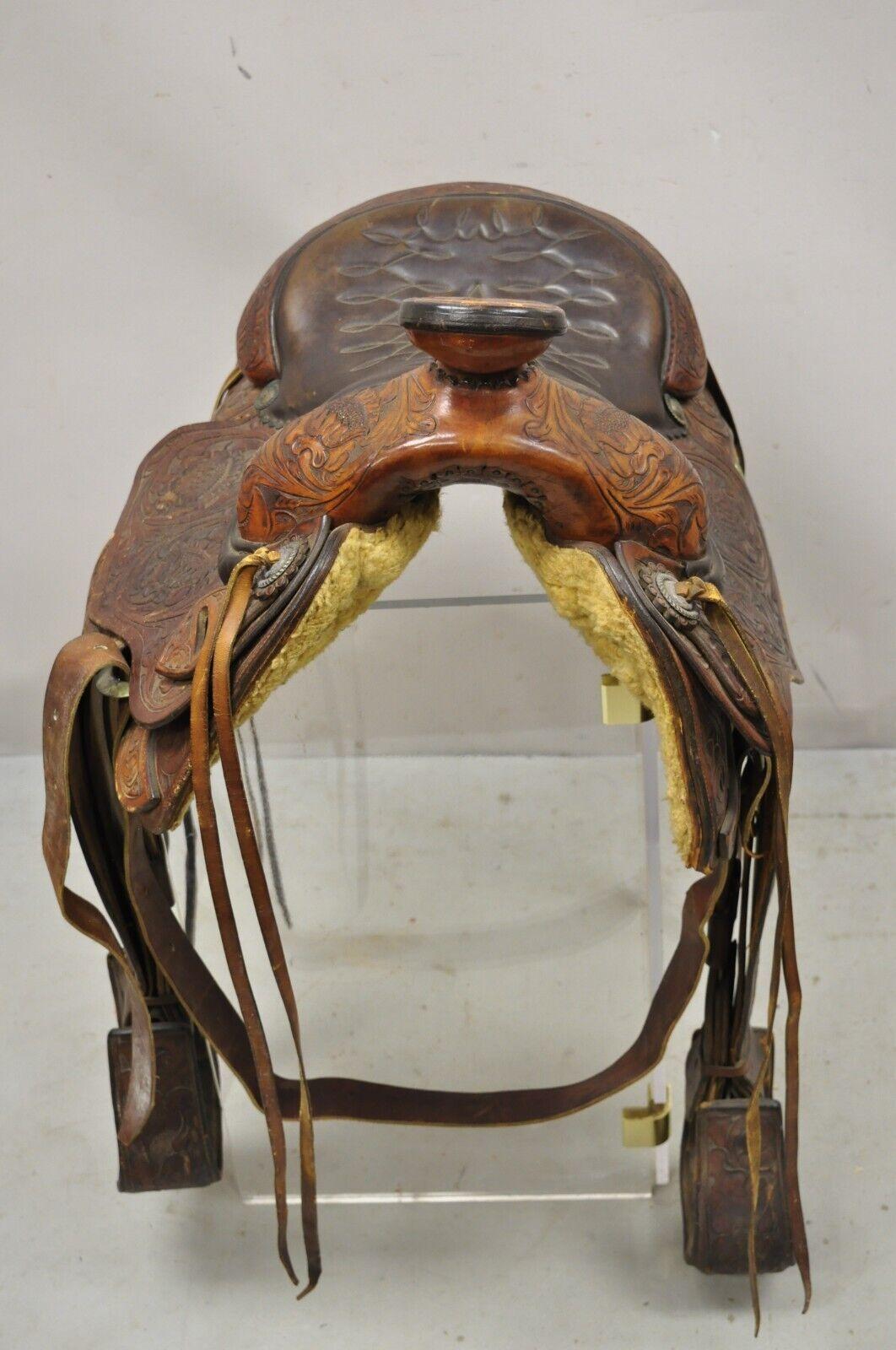 Vintage ML Leddy's Brown Tooled Leather Western Show Horse Saddle. Item features full tooled leather floral detail, original maker stamp, quality American craftsmanship. Circa Mid to late 20th Century. Measurements: 16