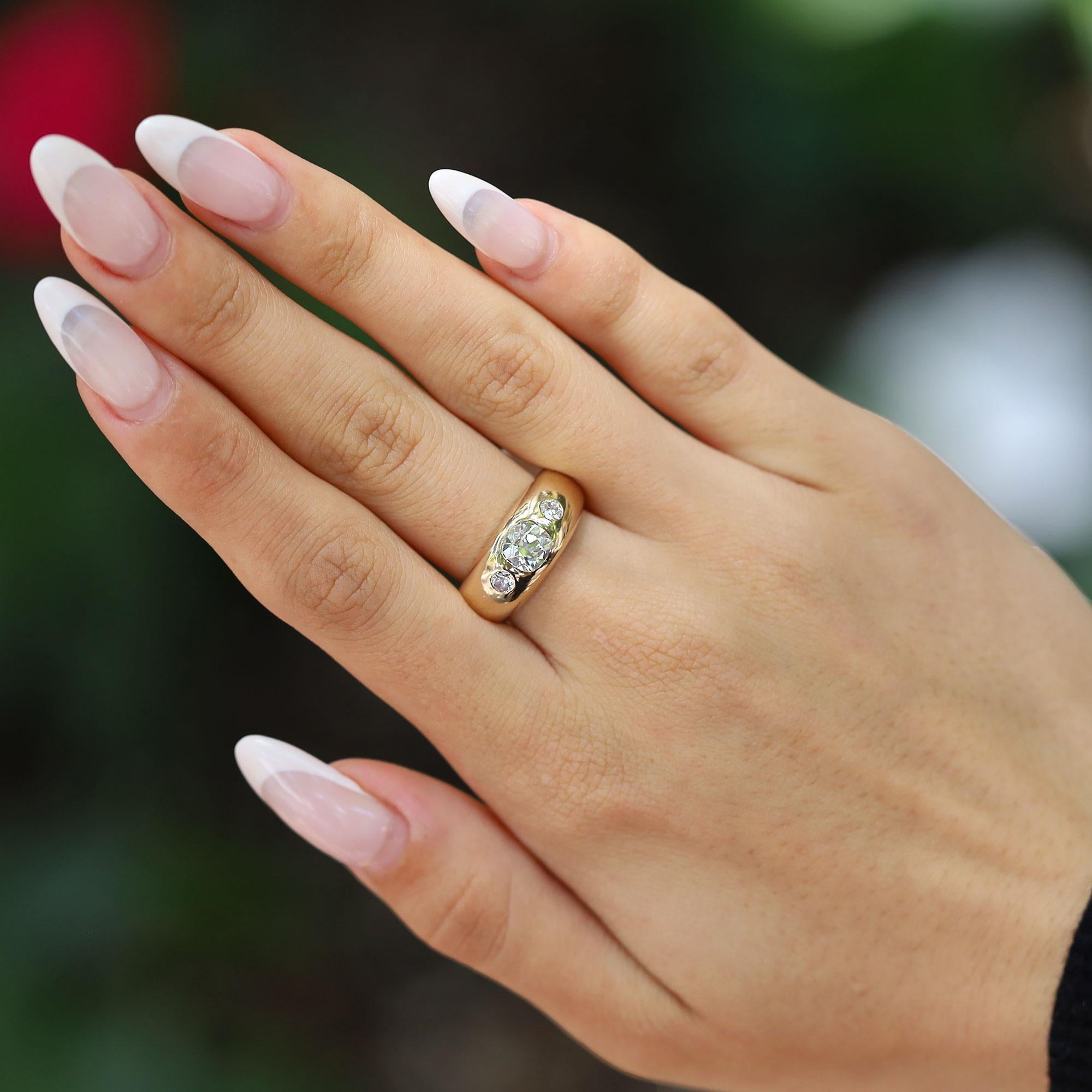 A phenomenal find, this vintage estate mobster style pinky ring showcases over 1 carat of antique old mine cut diamonds in an entrancing gypsy setting. The 18 karat yellow gold bombè band makes for a sophisticated accessory suitable for a formal