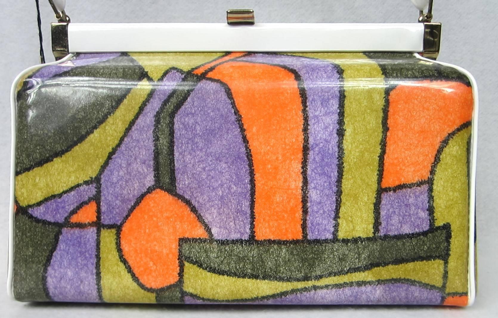 Pucci inspired colors on this Dead Stock 1960s Hand bag with a wonderful Red Lining. White handle. Gold-tone Hardware and footed. Measures 10.5 inches w  x 6.5 inches h x 3.5 inches. Handle drop 5 inches Inside zippered compartment. Original  Verdi