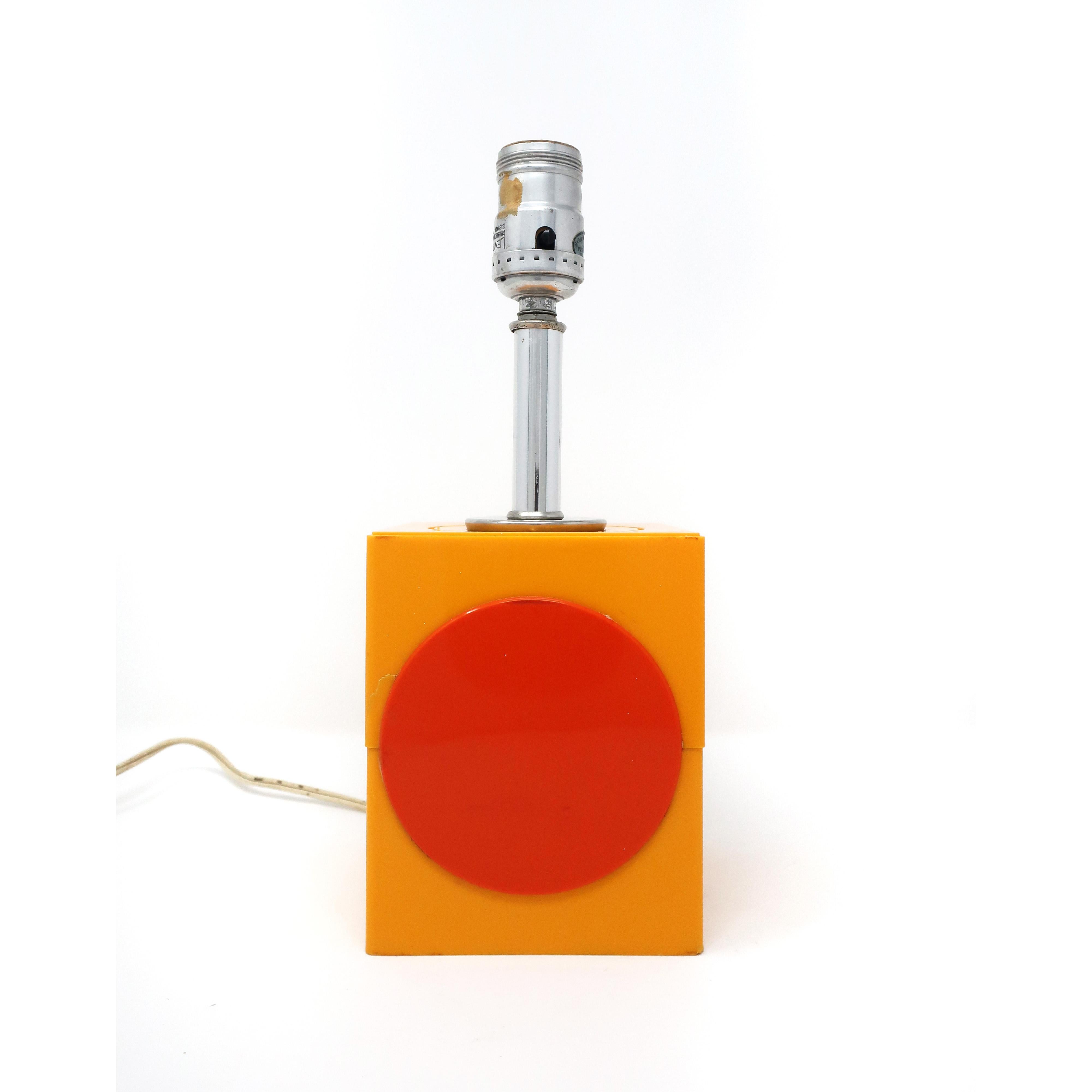 A Mid-Century Modern orange table lamp with red accent and chrome stem. Perfect in an entry way, on a bedside table, or as a desk lamp. Will look great with a frosted globe bulb or a clip on lamp shade. 

In good vintage condition with signs of
