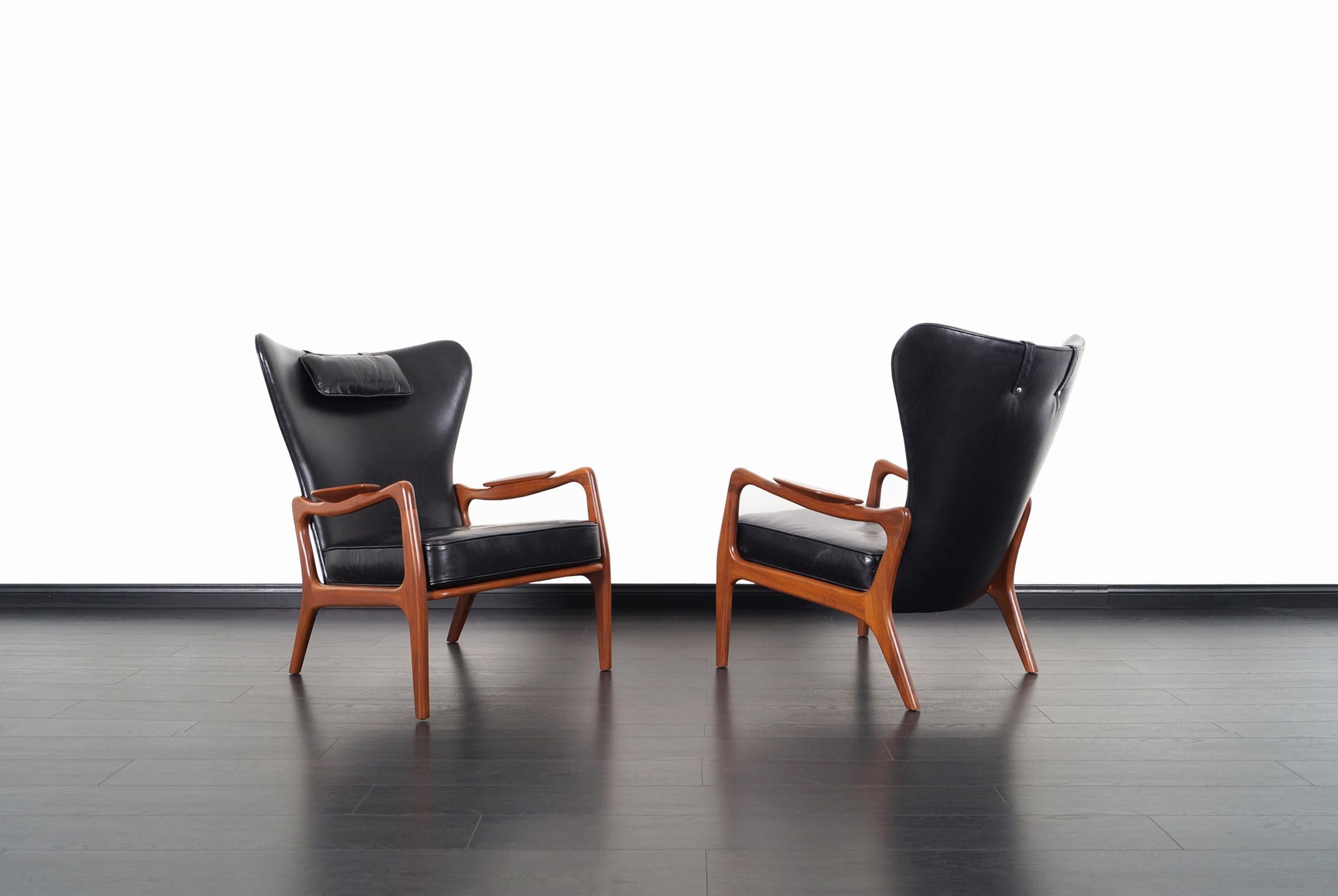 Visually stunning pair of leather lounge chairs designed by Adrian Pearsall for Craft Associates in the United States, circa 1960s. This rare pair of wingback chairs, also known as model 1410-C features a sculptural walnut frame with a striking