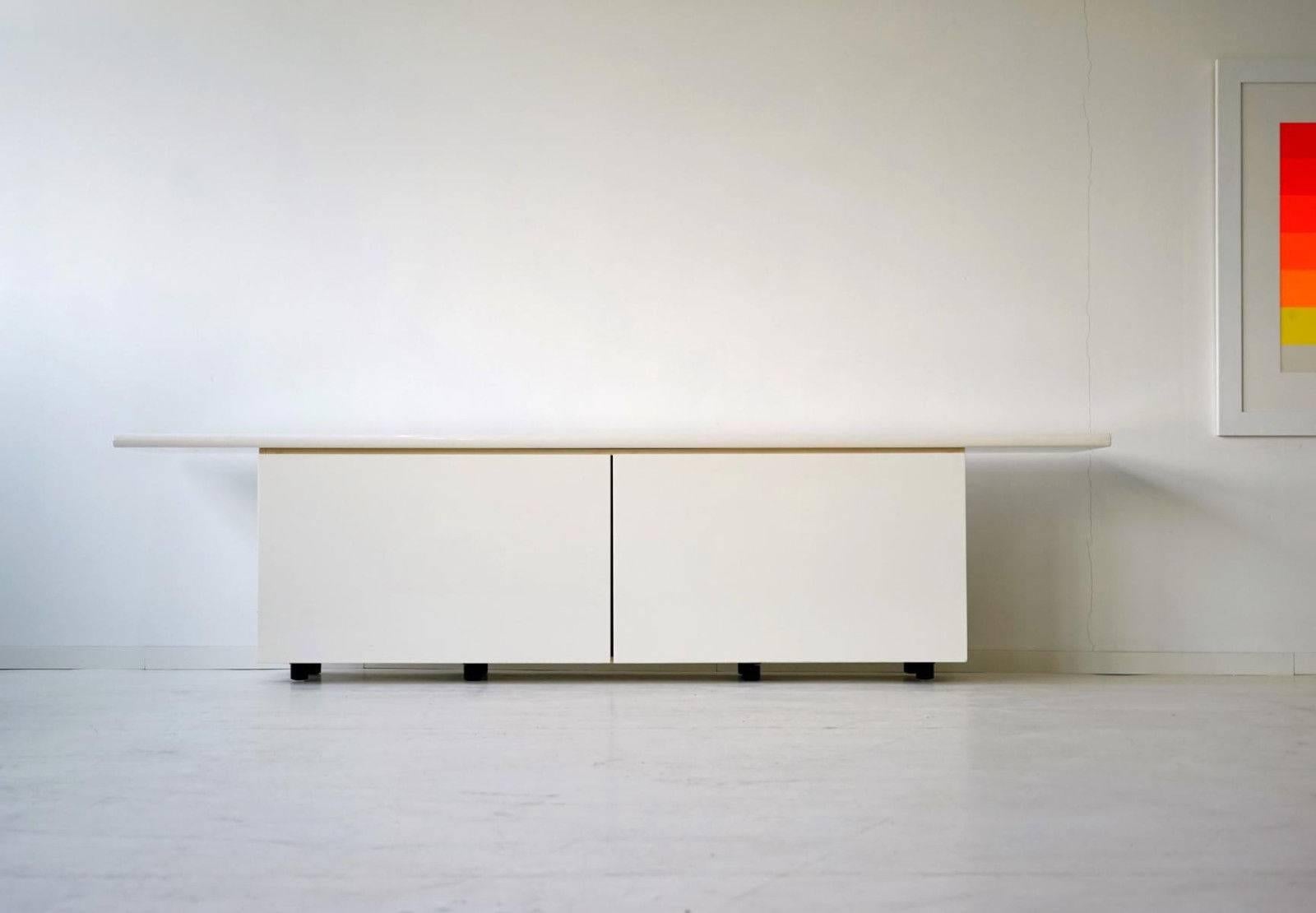 White model Sheraton sideboard.
Features wide doors that slide and swing. Simple and timeless design. 

+ Very good quality
+ Simple and timeless design
+ Very practical due to the sliding swing-door system.