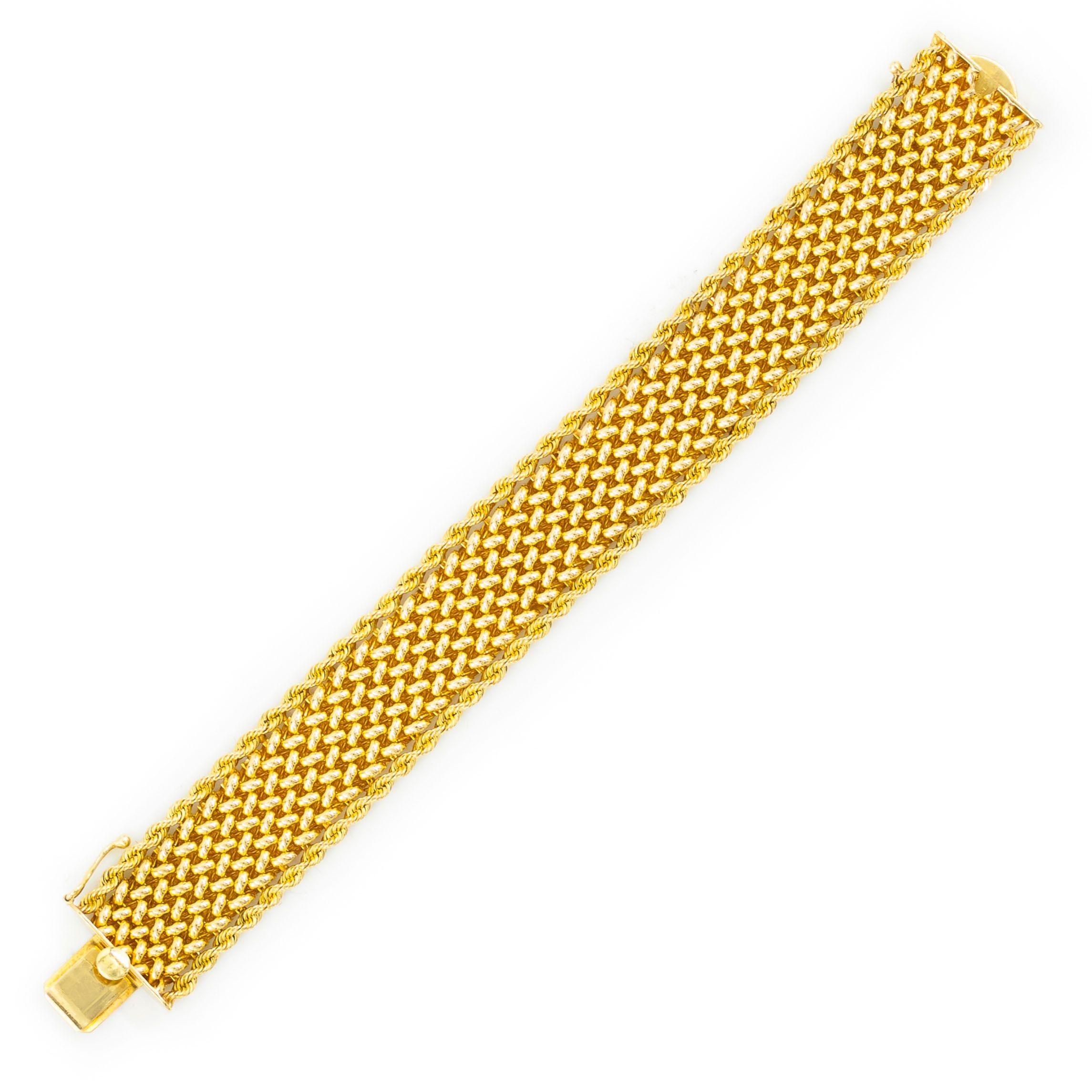 A very attractive and rather substantial vintage bracelet designed by the Los Angeles jeweler Carl D. Linstrom & Sons entirely in 14 karat yellow gold to include a silky woven mesh body with a twisted-rope edging. The angles of the rope edge and the