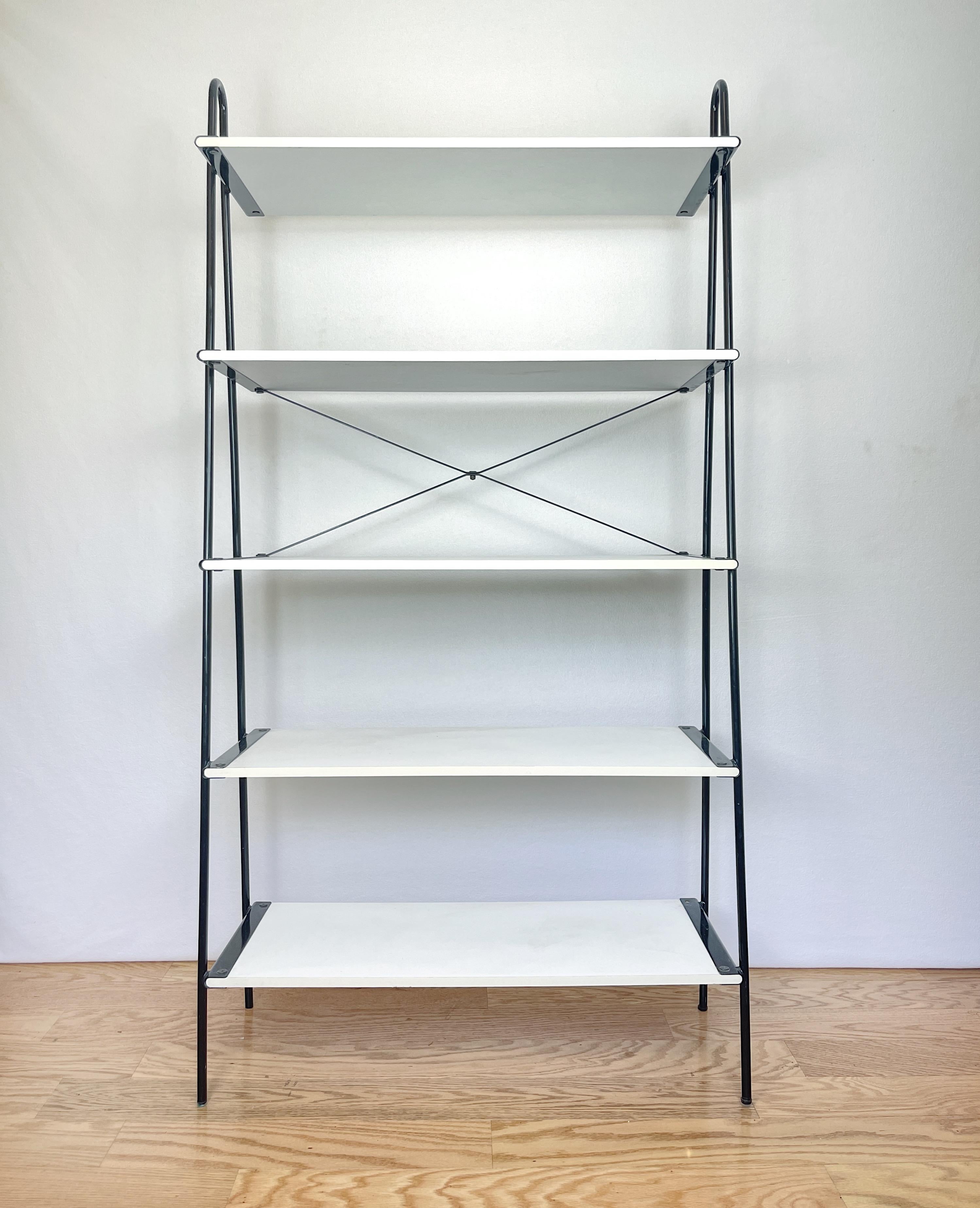 Vintage architectural l-adder sided shelving unit with white Formica laminated wood shelves and black powder coated steel frame.  Thoughtfully designed with uniquely rounded edged Formica shelving that fit elegantly fit into customized slots of the