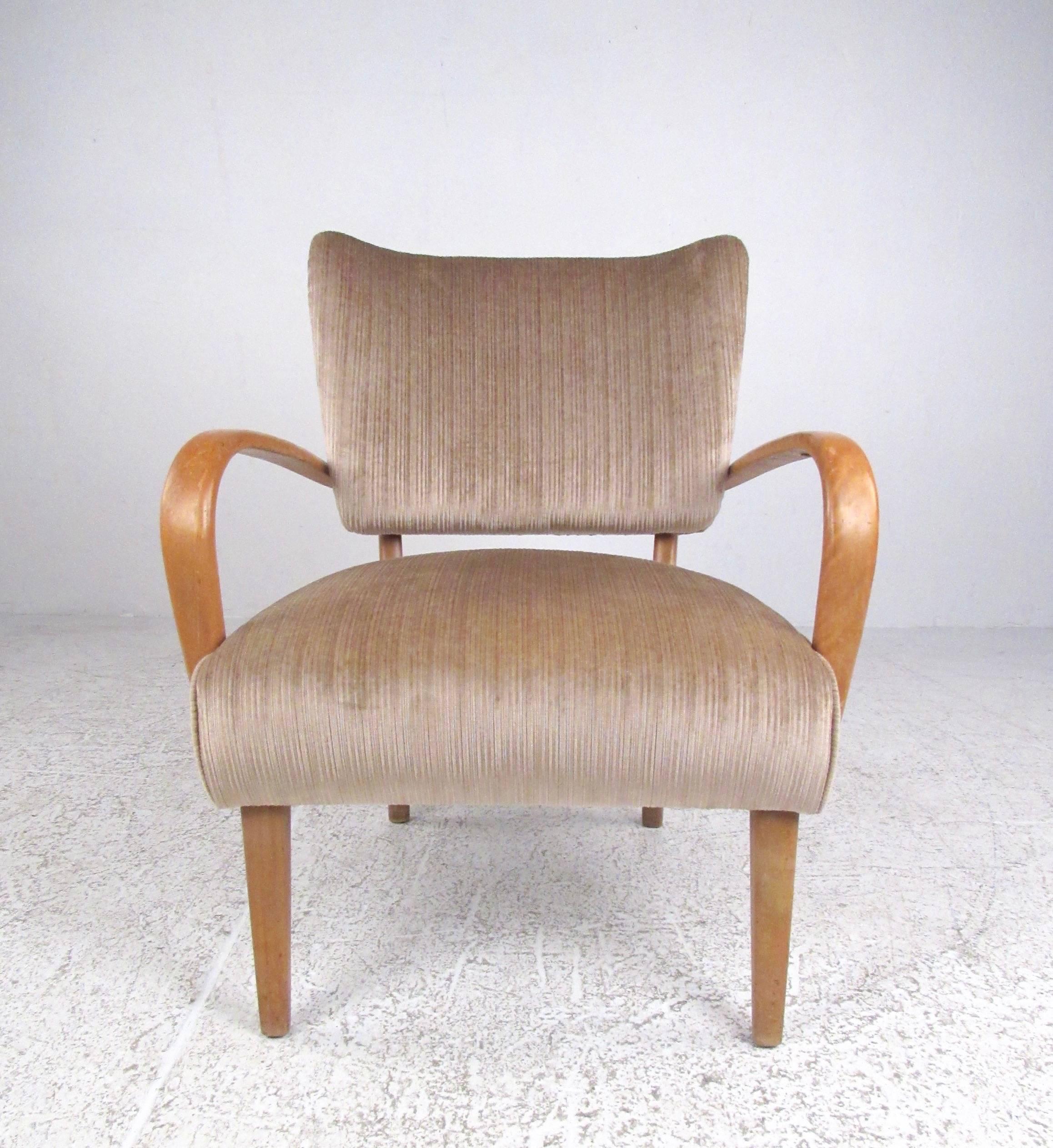 This stylish Italian modern style armchair features sculpted hardwood frame with plush upholstered seat and back. Vintage covering, stylish tapered legs, and unique Mid-Century Modern appeal makes this a perfect sitting chair for home or office,