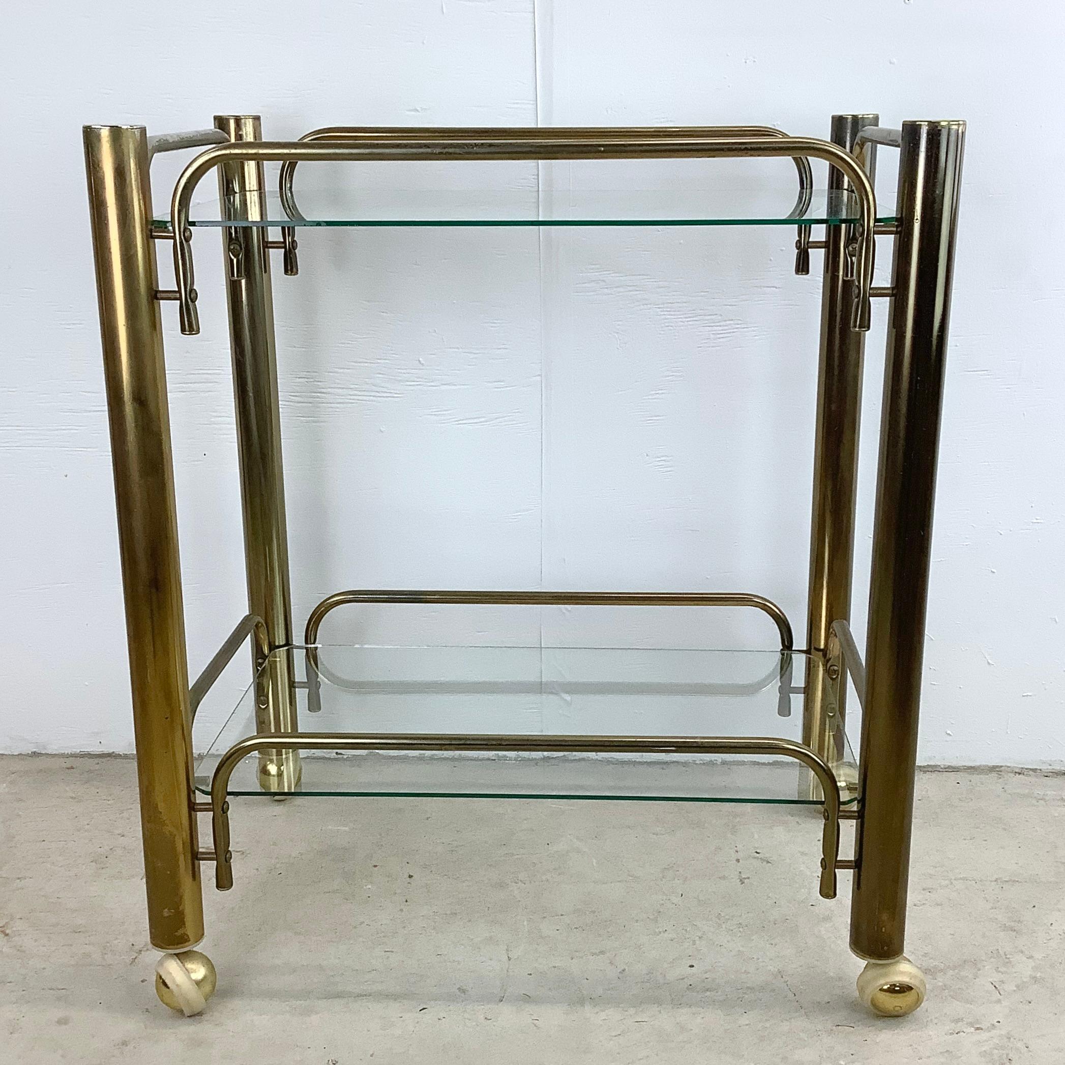 Introducing this Vintage Modern Brass Finish Metal and Glass Bar Cart, a stunning piece that exudes timeless glamour and functionality. Available now, this bar cart is a true vintage gem that adds a touch of elegance to your entertaining