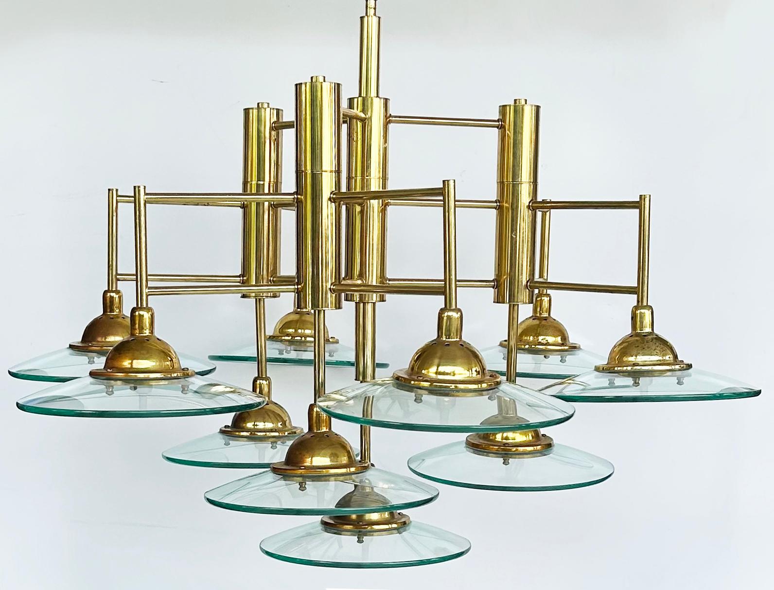 Vintage Modern Brass and Glass 10-Light Chandelier

Offered for sale is an unusual modern multi-tiered chandelier in brass with glass disks. The chandelier has 10 lights each surrounded by thick glass disks. It does not have the original canopy but