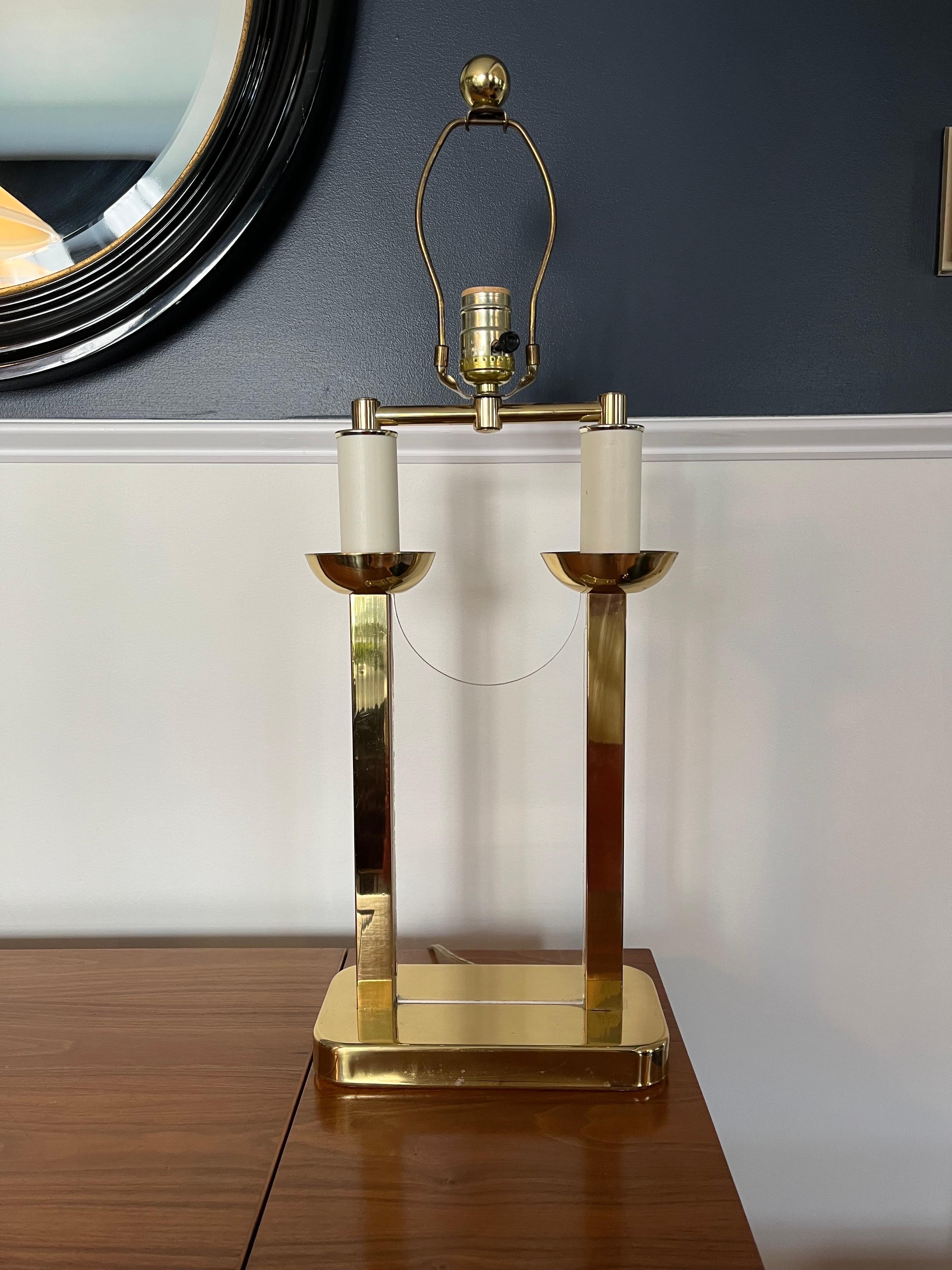 Great modern twist on the classic bouillotte lamp. Brass candle sticks lucite panel to separate. Clean sophisticated lines in the manner of Tommi Parzinger. 