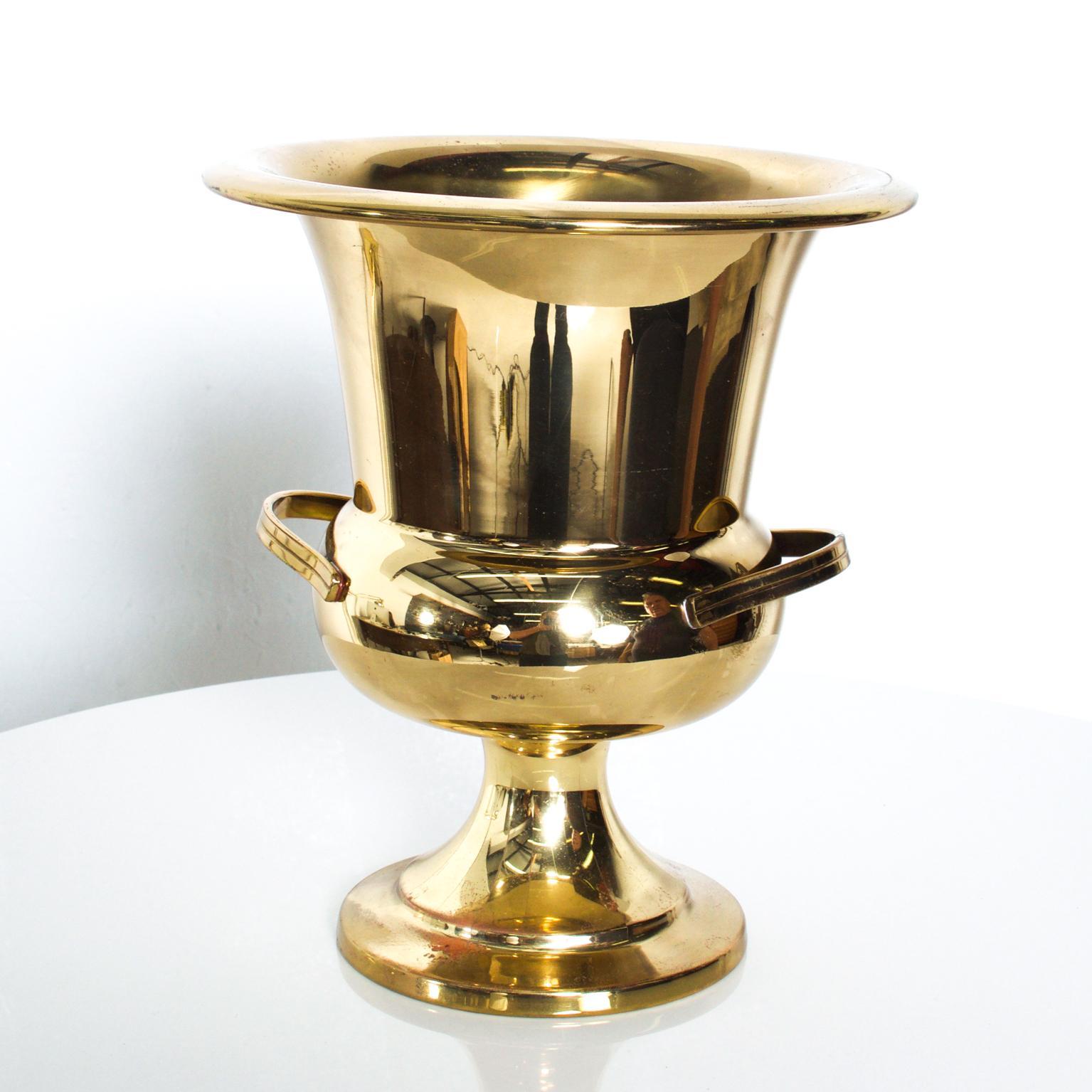 For your consideration: an Elegant Vintage Midcentury Hollywood Modern Brass Plated Gold Champagne Wine Bucket Holder. It dates from the 1960s. Attributed to Tommi Parzinger. 
Dimensions are: 8 5/8