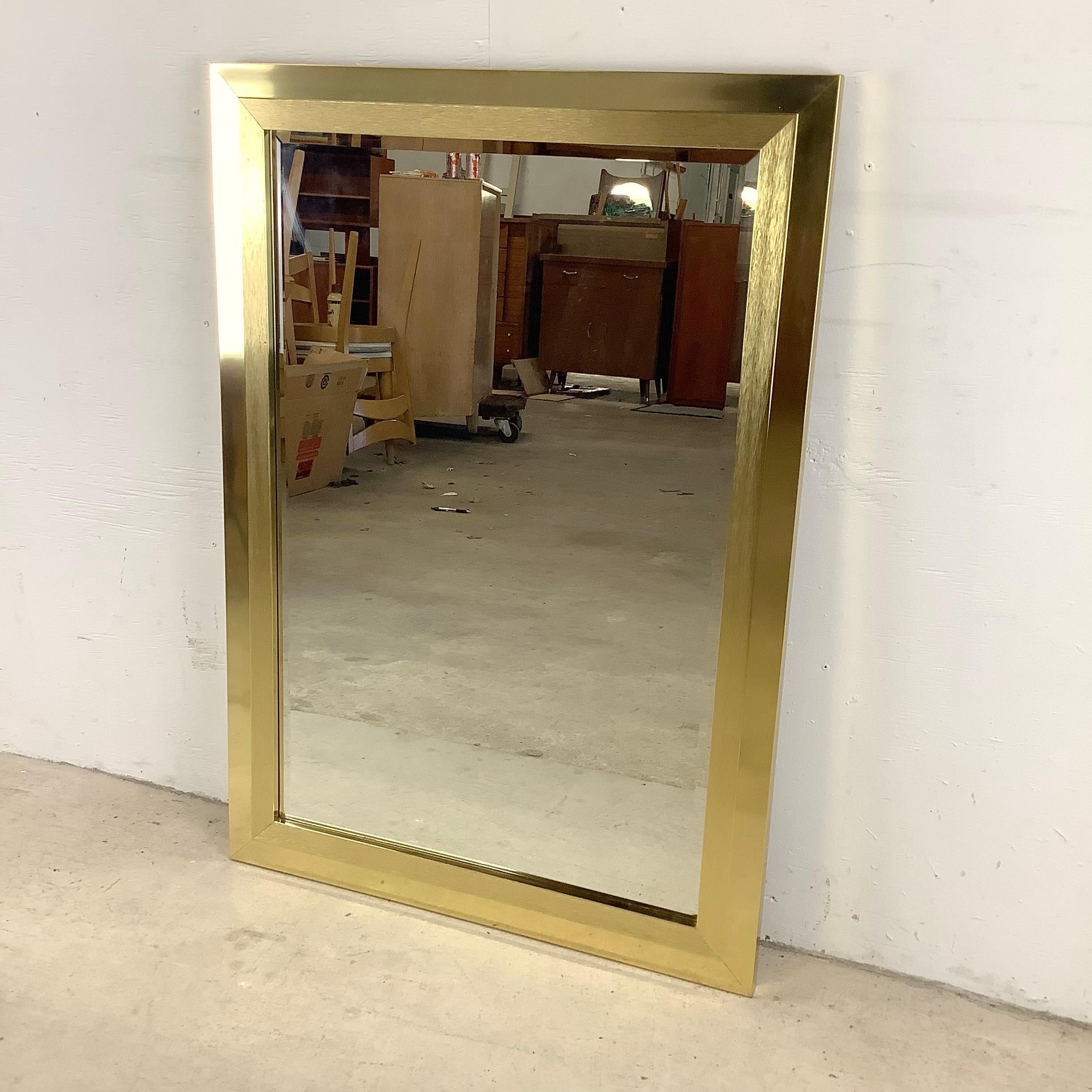 This striking vintage modern brass frame mirror comes ready to hang and adds subtle mcm style to any setting. The perfect size for vanity mirror. 

Dimensions: 29w 1d 41.25h

Condition: age appropriate wear, vintage finish worn,