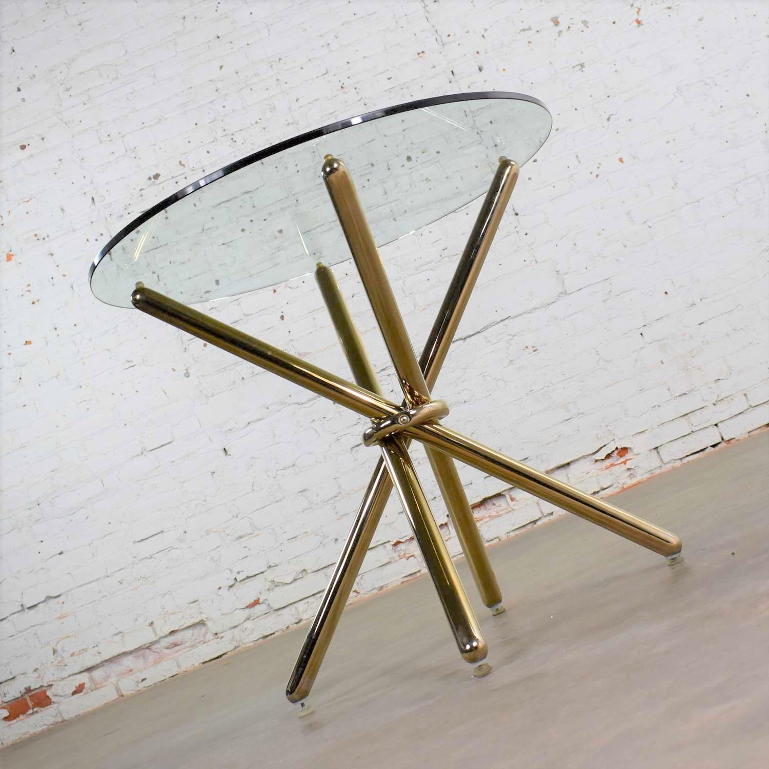Handsome vintage modern brass-plated jax center table or end table with a 30-inch round glass top. It is in wonderful vintage condition. There may be some small signs of age to the brass-plated tube, but the glass is new. Please see photos, circa