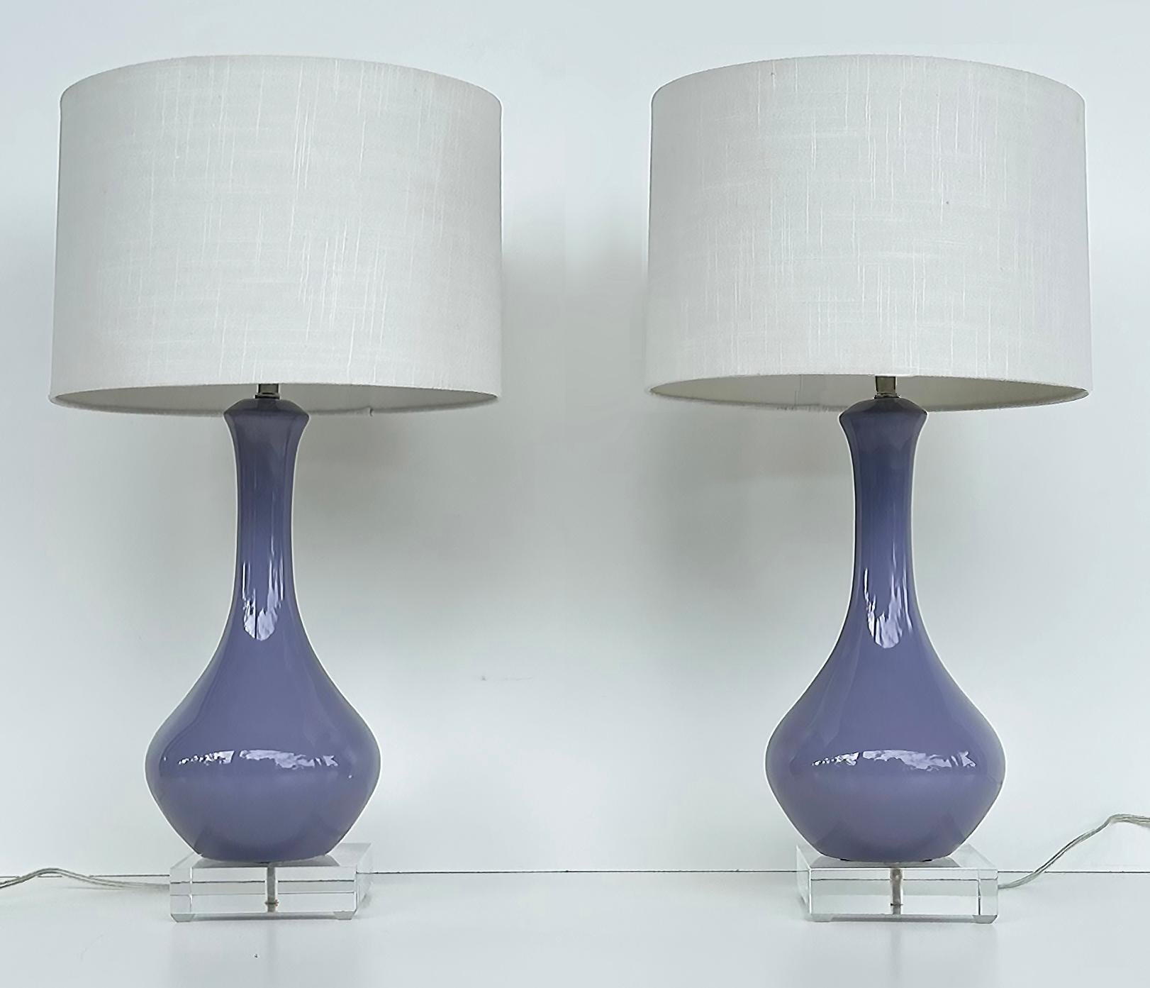 Vintage Modern Ceramic Table Lamps on Square Lucite Bases 

Offered for sale is a vintage pair of ceramic table lamps raised on thick square lucite bases.  The lamps are wired and in working condition.  They include the harps and finials but not the