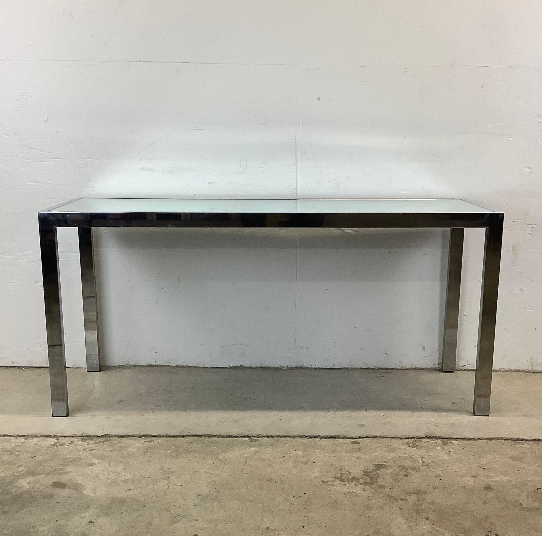 This vintage console table offers just the right dose of drama for your entryway, living room, or hallway. Featuring a thick chrome frame and a mirrored glass top, it’s the kind of piece that immediately commands attention without ever