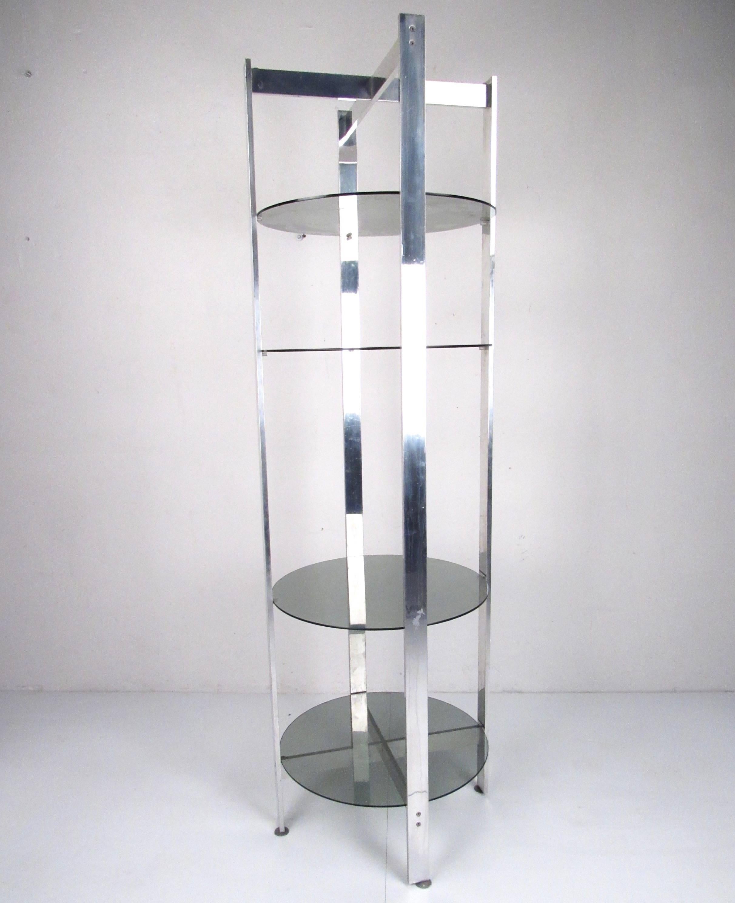 This stylish Mid-Century Modern shelf unit includes smoked glass shelves in an x-style frame, ideal for shop or home display. Vintage display étagère makes a striking modern addition to any interior. Please confirm item location (NY or NJ).
