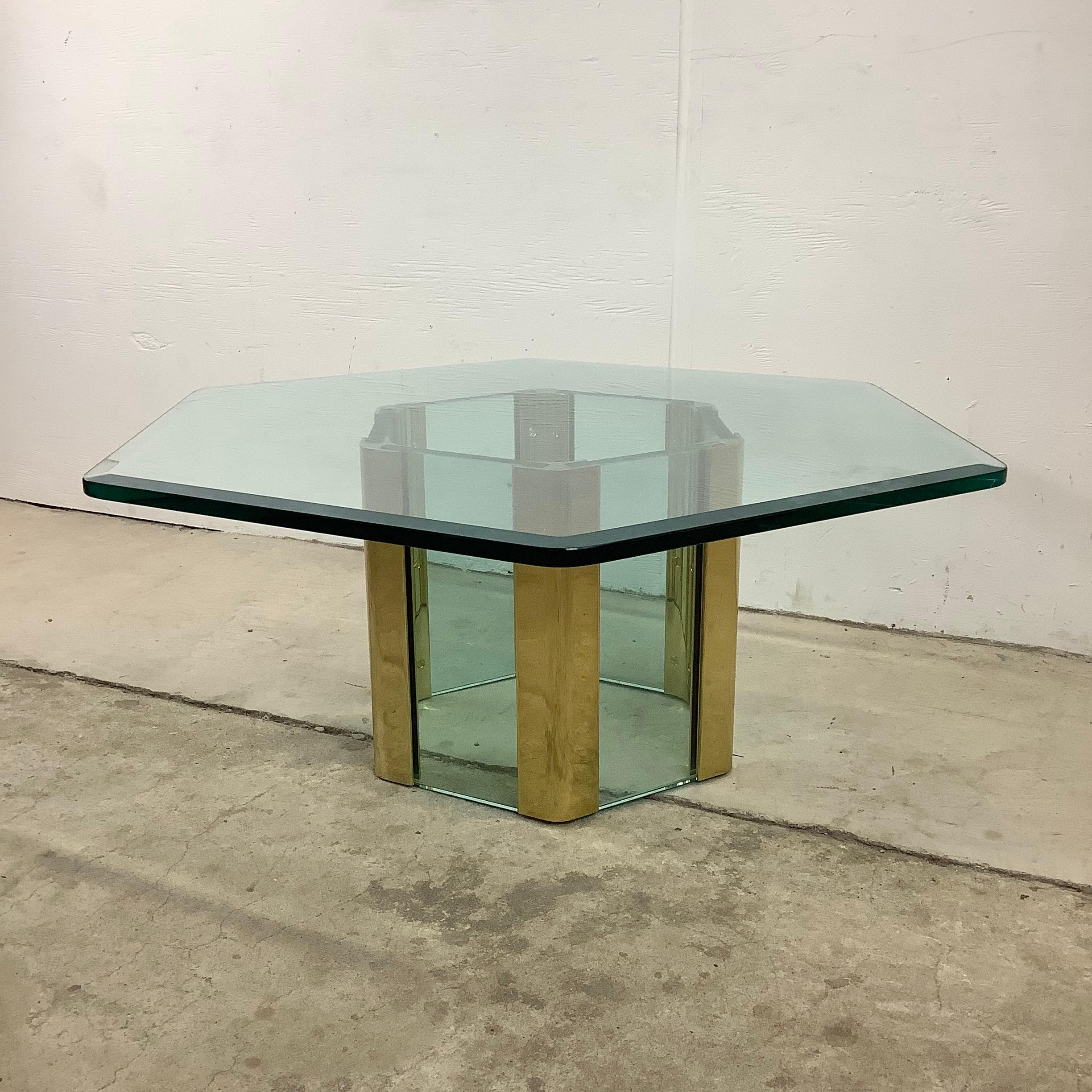This striking Mid-Century Modern coffee table features a unique mix of brass and glass in a hexagonal design with a thick beveled glass top. An eye catching mixture of clean modern lines and quality vintage craftsmanship make this Leon Rosen for