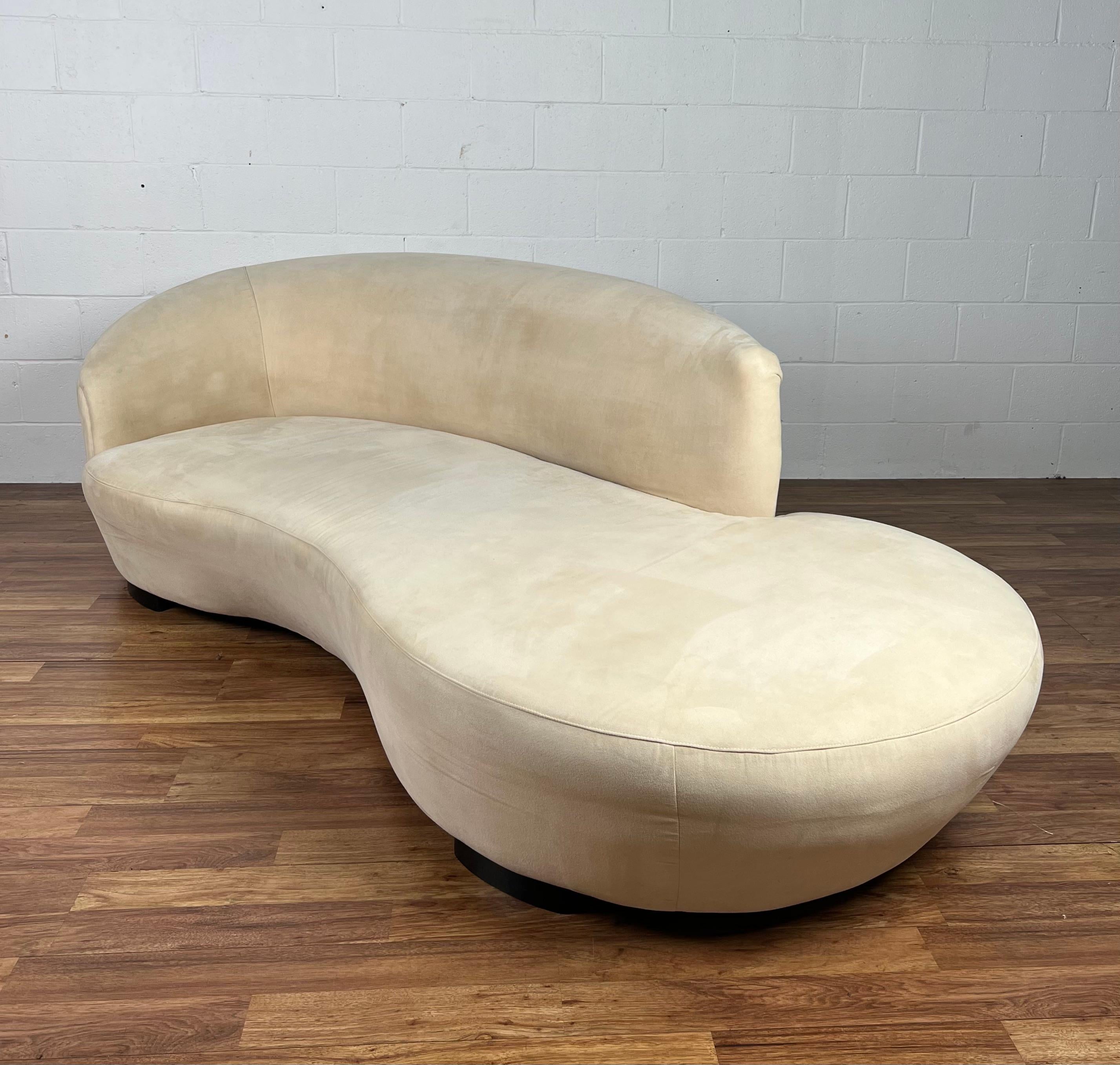 For your consideration we offer this elegant curvaceous vintage sofa in original champagne Ultrasuede with ebony finished bases. The fabric show minimal spotting from use and moving and could be professionally cleaned or reupholstered prior to