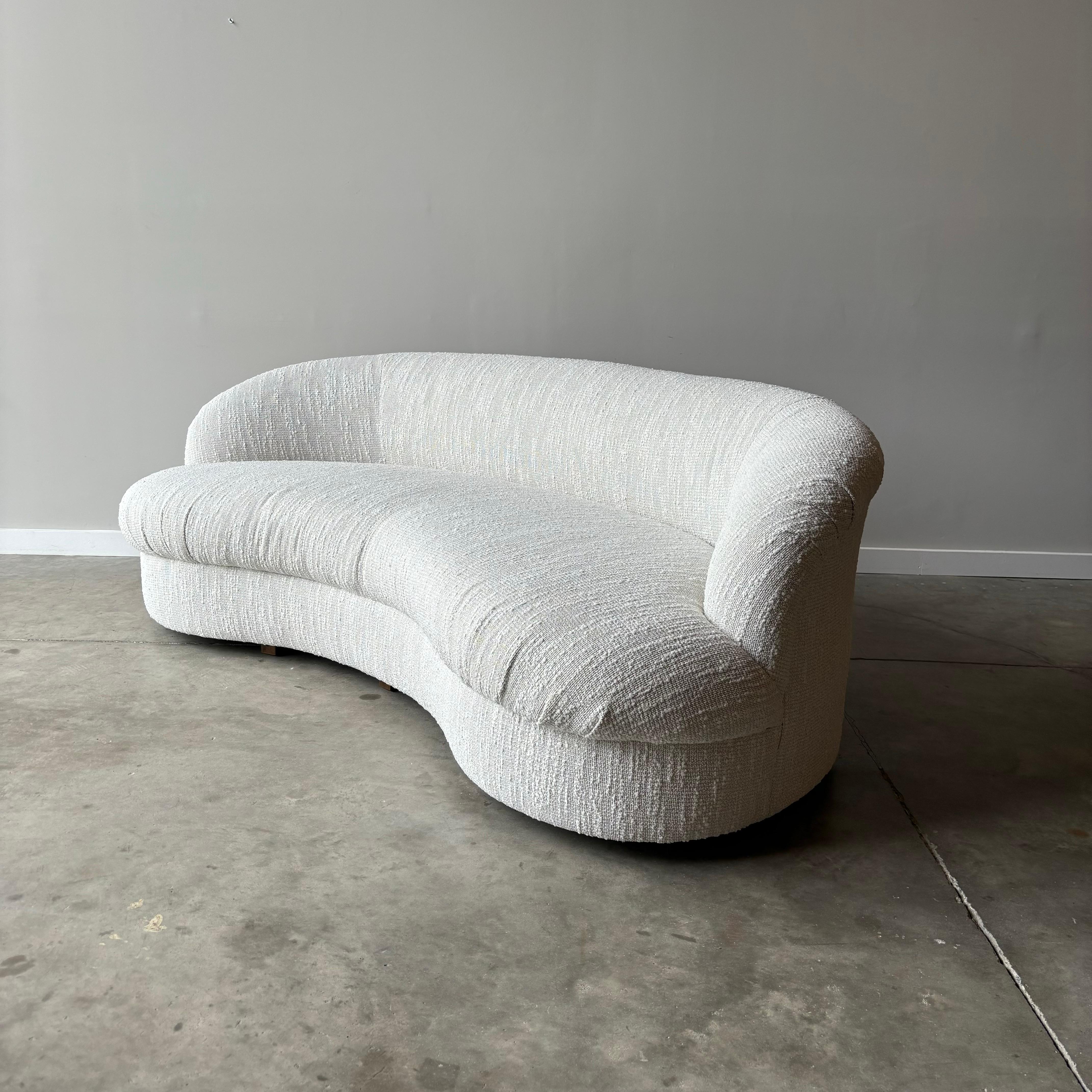 Beautifully restored vintage curved sofa in new striated boucle upholstery.  


Pair Available