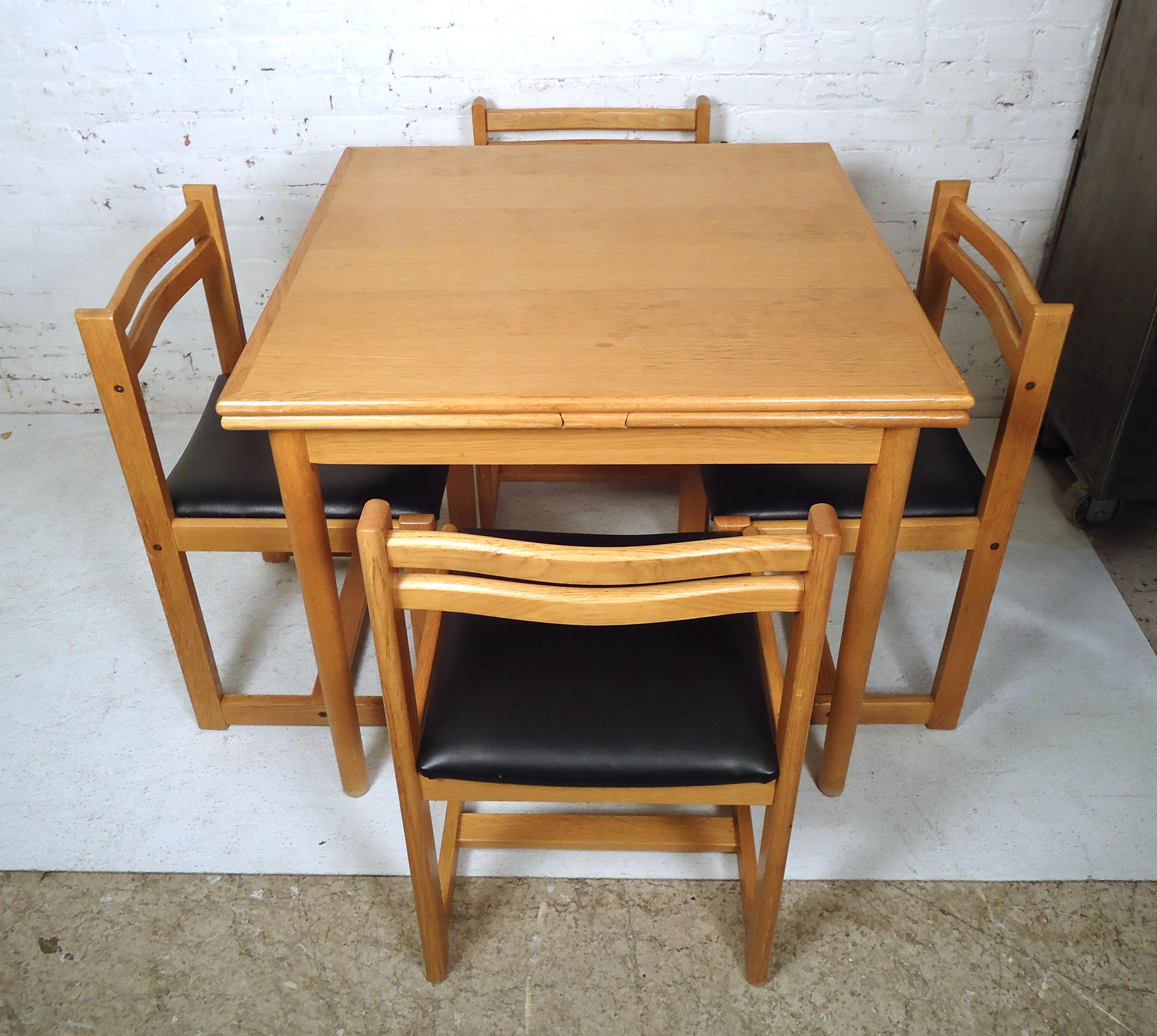 Great Mid-Century Modern extendable dining table made of rich teak grain throughout features four Danish chairs with vinyl cushions.

Extended measurements: 64W 33.5D 29.5H
Chair measurement: 18W 17D 29H 
SH: 17

Please confirm item location