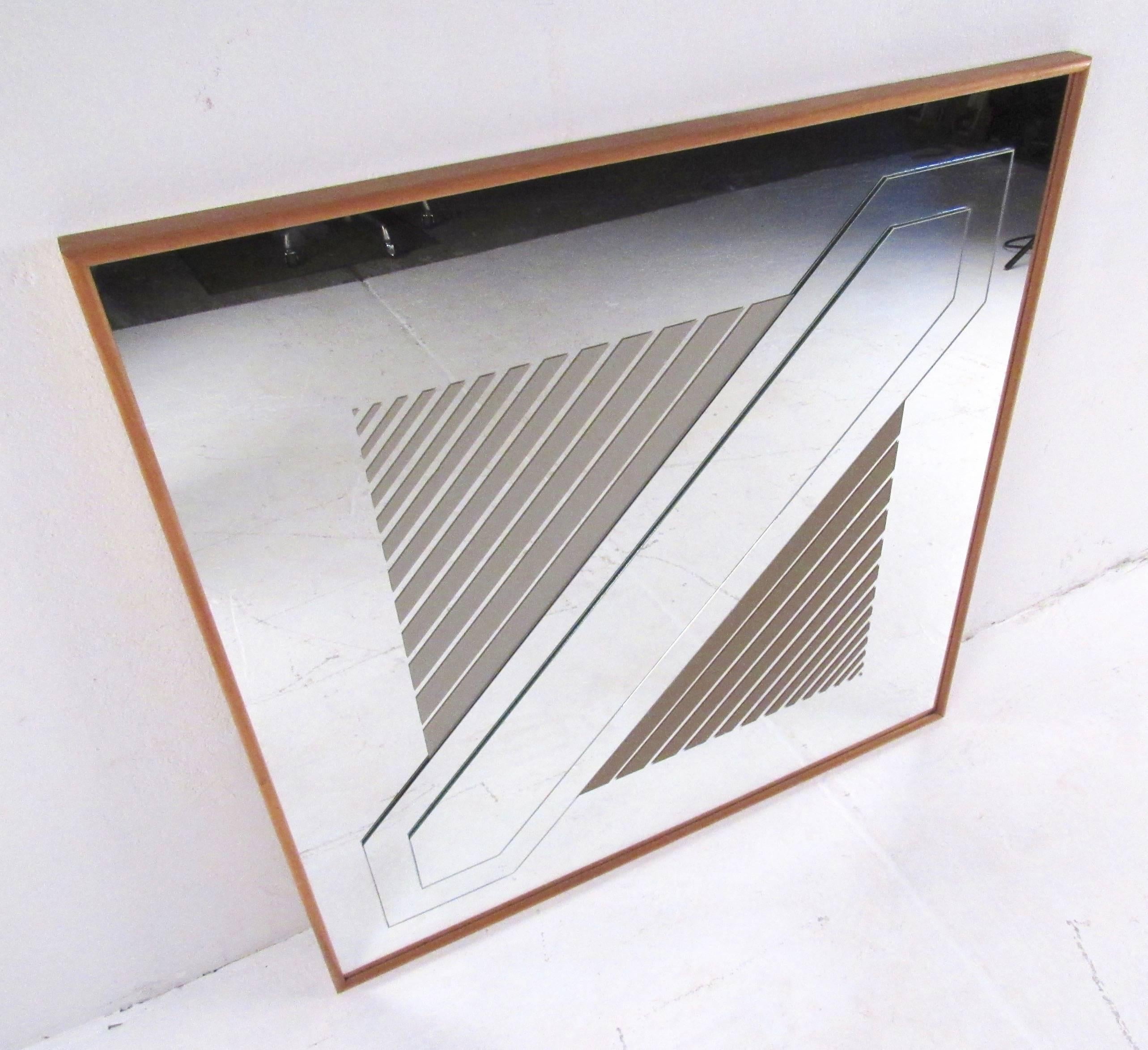 This vintage Mark Warren decorative mirror features geometric design in applied finish and etched glass pattern. Marked 1977, this vintage mirror comes mounted in a hardwood frame and makes a unique retro addition to home, business, or office.