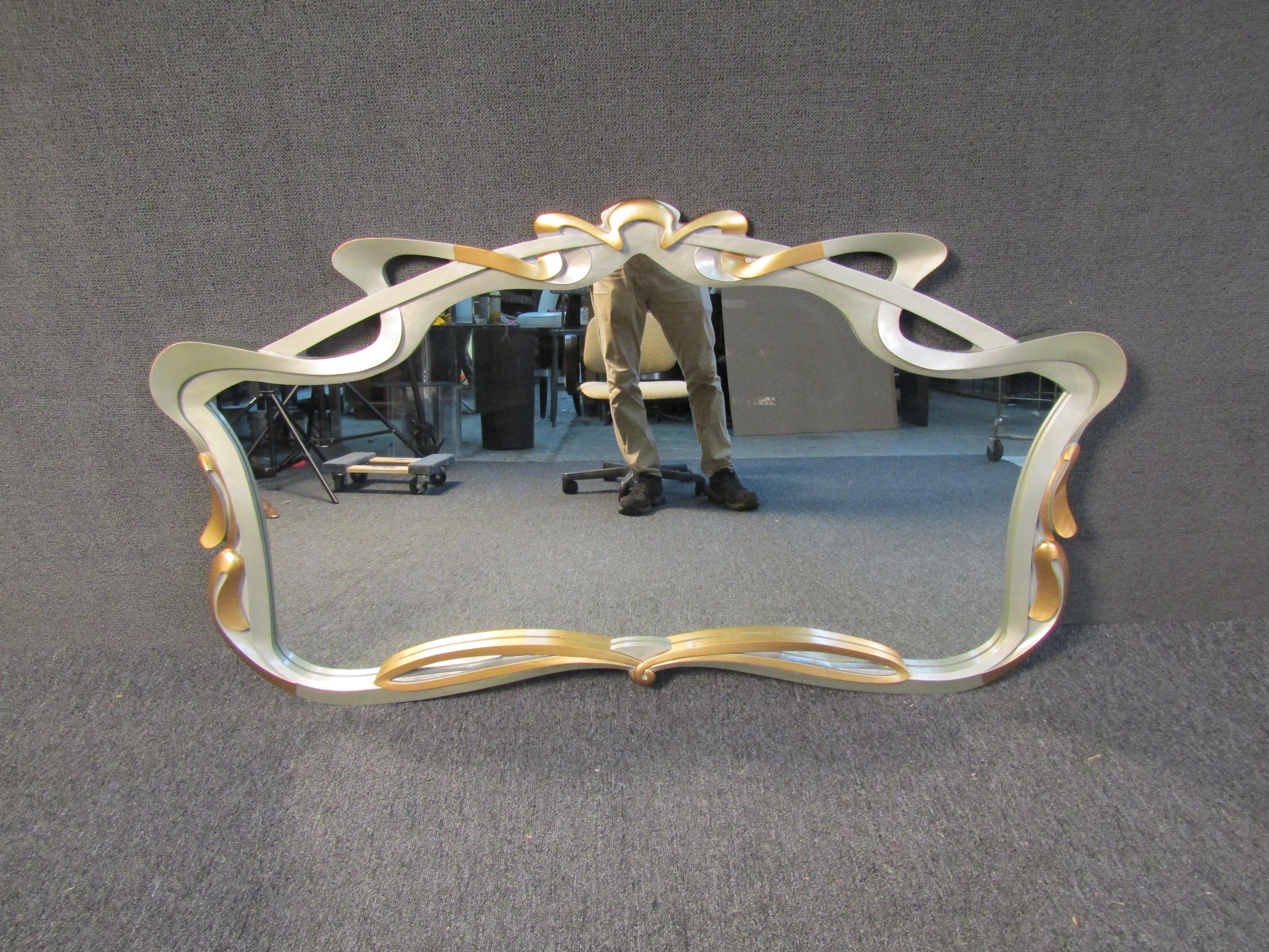 Warm and whimsical, this elegant wall mirror brims with vintage allure. Its fantasy-like approach and detailed curvature allow it to Stand out in any home or office. Please confirm item location (NY or NJ) with dealer.
