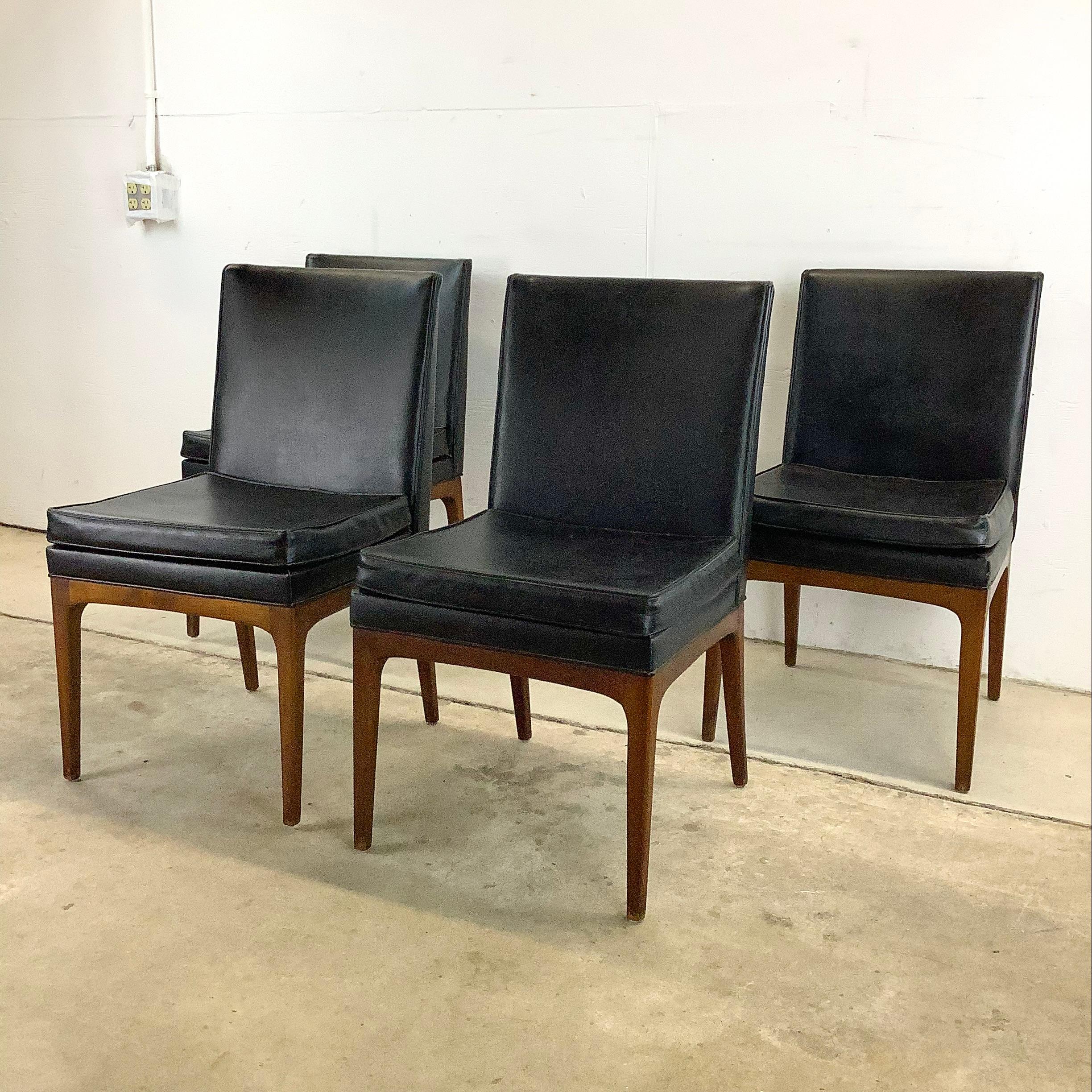 This stylish matching set of four dining chairs features durable naugahyde style upholstery, solid wood frames, and shapely mid-century modern style design. Comfortable set of mid-height seat back dining chairs make the perfect mcm seating option