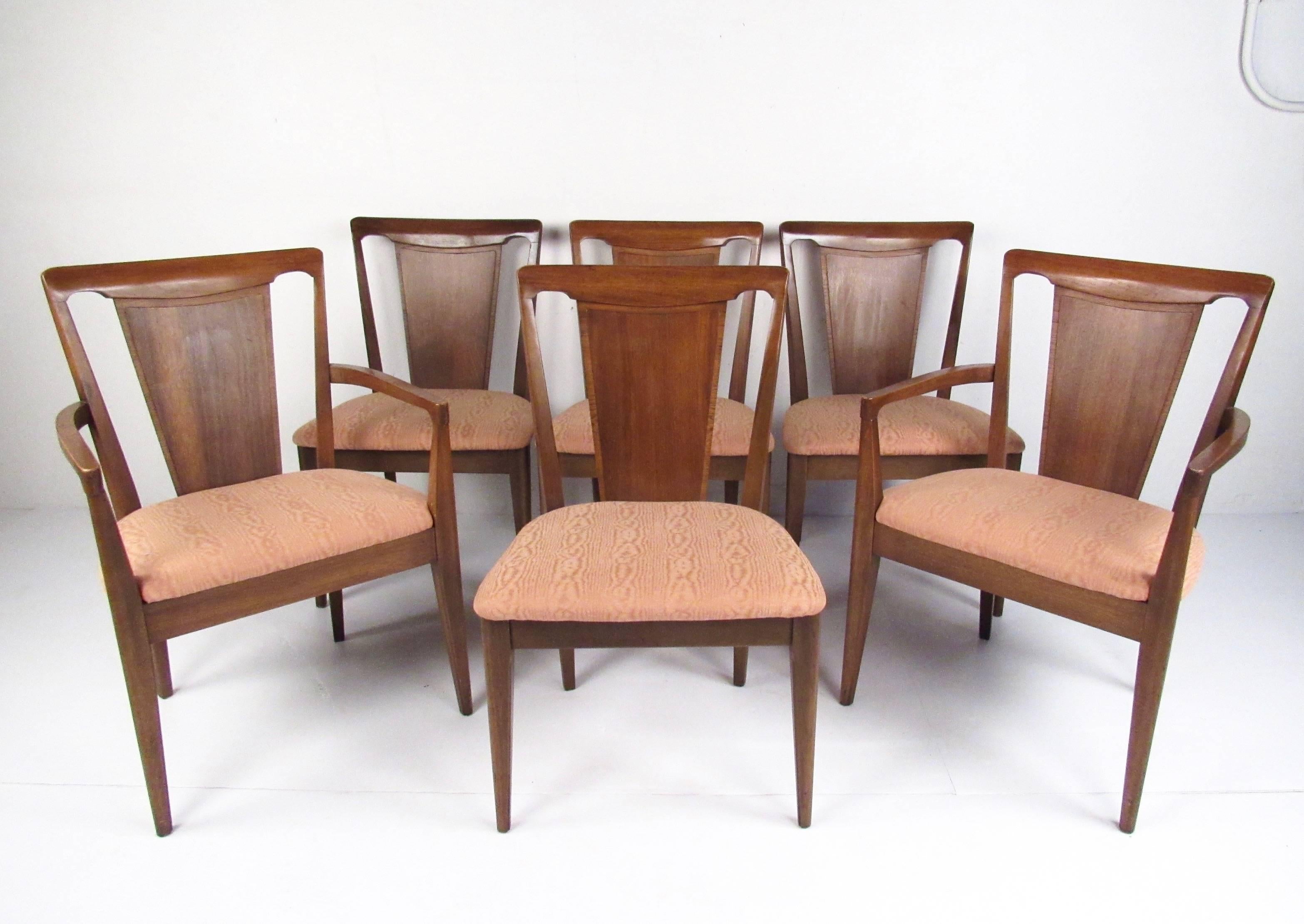 This stylish set of six matching dining chairs features heavy midcentury pecan construction, unique modern shape, and vintage seat covering. Ideal set of modern hardwood dining chairs for luxury home dining room. Please confirm item location (NY or