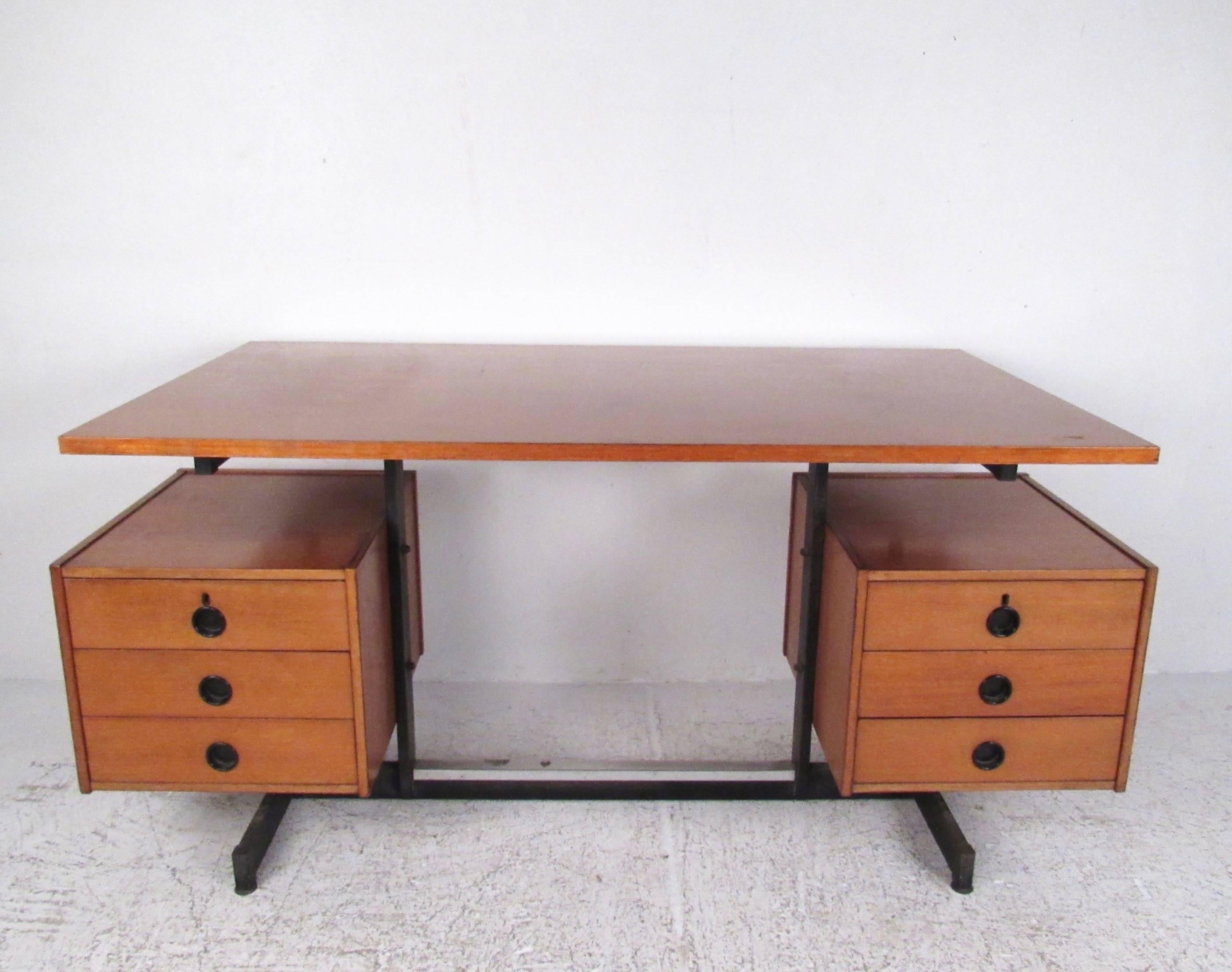 This stylish Italian modern desk features quality teak construction, floating top design, and six drawers for plenty of storage. Unique drawer pulls and midcentury design add to the vintage charm of this impressive writing desk, perfect for home or