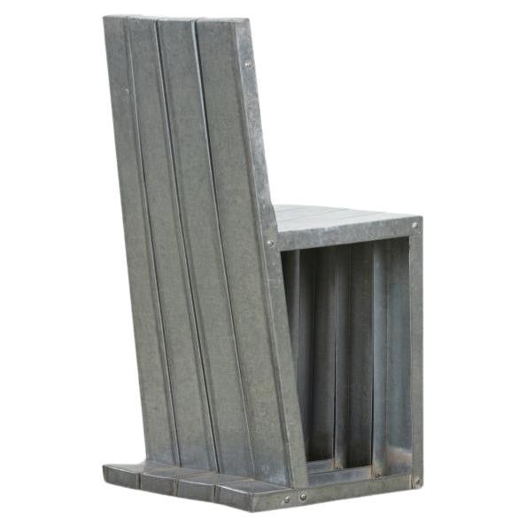 A very unique, galvanized metal chair with a sculptural appeal. 
This will become a conversation piece. As the unexpected charm and character draws the attention of everyone who encounters it. It's a lovely addition to any home and its almost