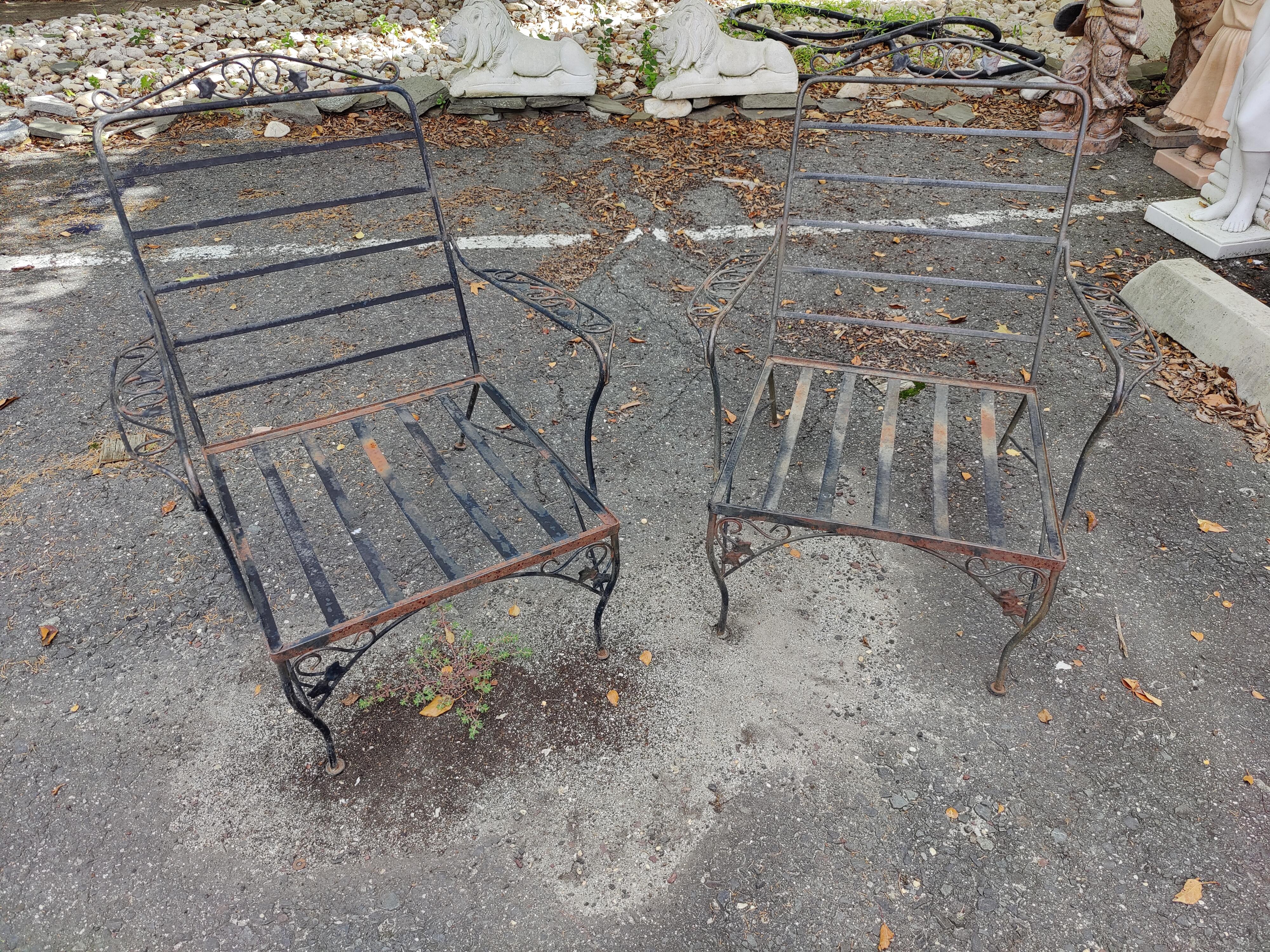 A pair of Mid-Century Modern outdoor lounge chairs. Made out of sturdy wrought iron. These lounge chairs feature elegant scrollwork and floral designs Perfect for any patio, pool, balcony setting. 
(Please confirm item location - NY or NJ - with